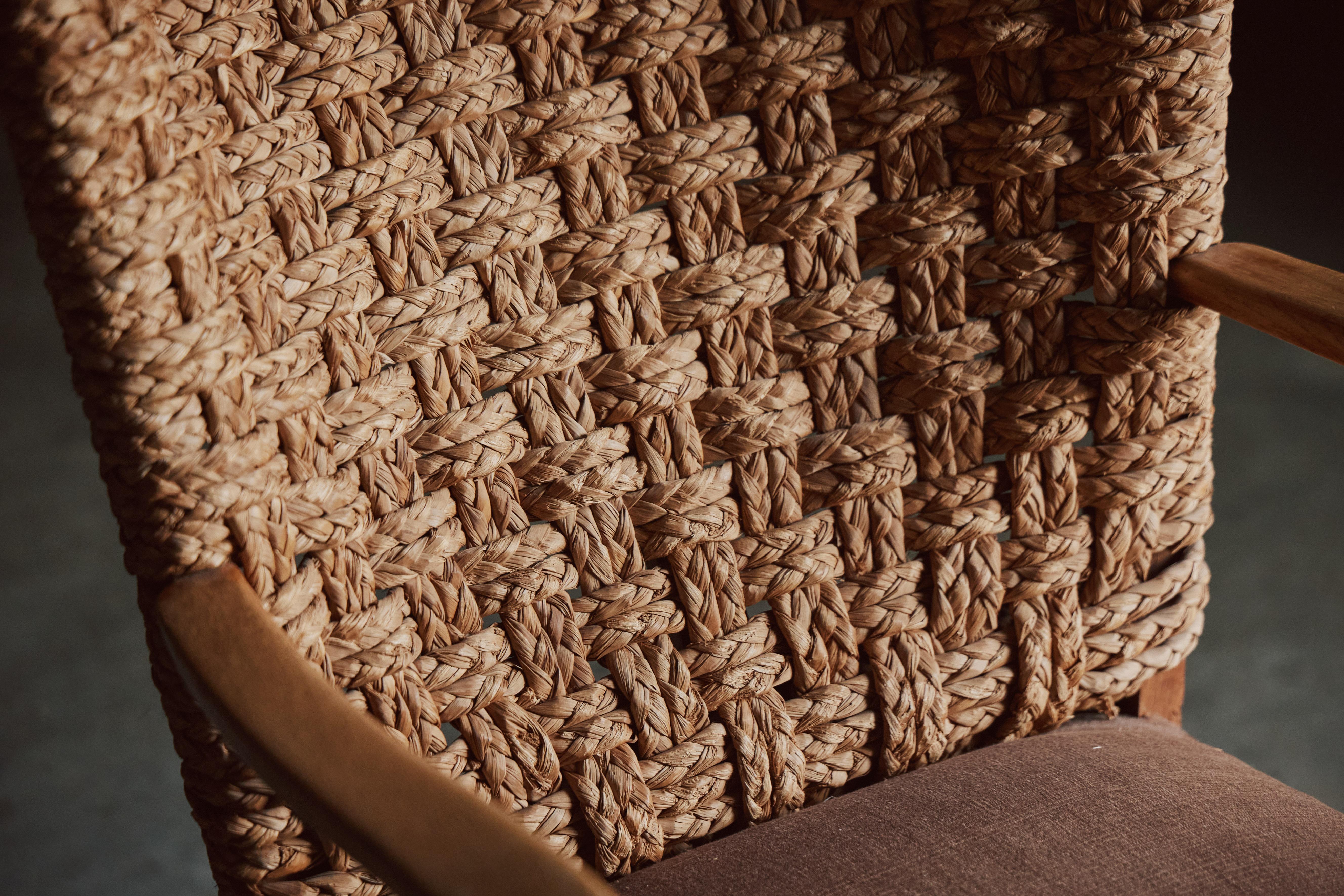 This armchair by Dutch designer Gerard van den Berg exemplifies his dedication to simplicity and distinctive form. The backrest is crafted with a woven cord, giving it a textured, organic appeal that contrasts beautifully with the warm, natural
