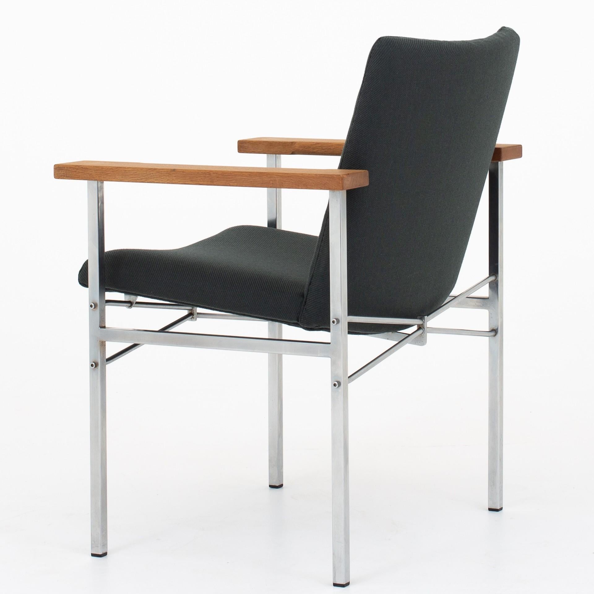 JH 704 - Armchair in steel and oak, reupholstered with twill weave wool from Kvadrat (col. 990). Maker Johannes Hansen.