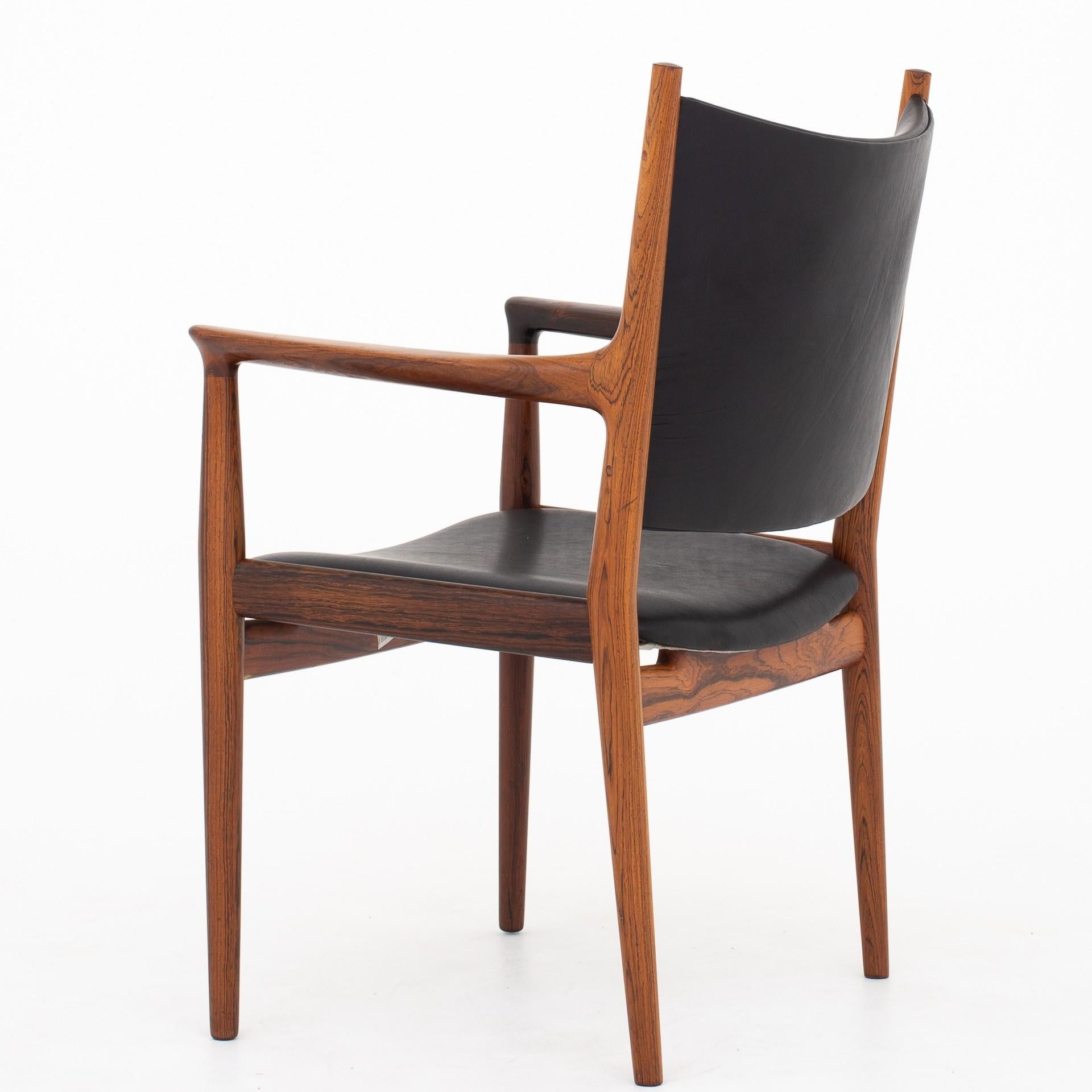 JH 513 - Armchair in rosewood, reupholstered in new Canyon leather. Johannes Hansen.
