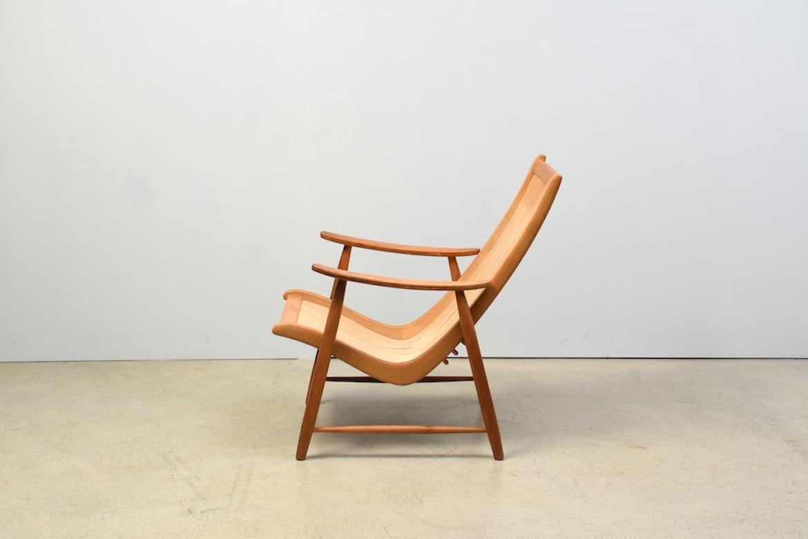 Armchair by Jacob Müller for Wohnhilfe, Switzerland, 1950s in ash and plywood. Tilt-adjustable armchair with movable layer-glued frame and separate base frame, with overlay, ash wood frame and aircraft plywood slats, high back rest. Height 84-10 cm.