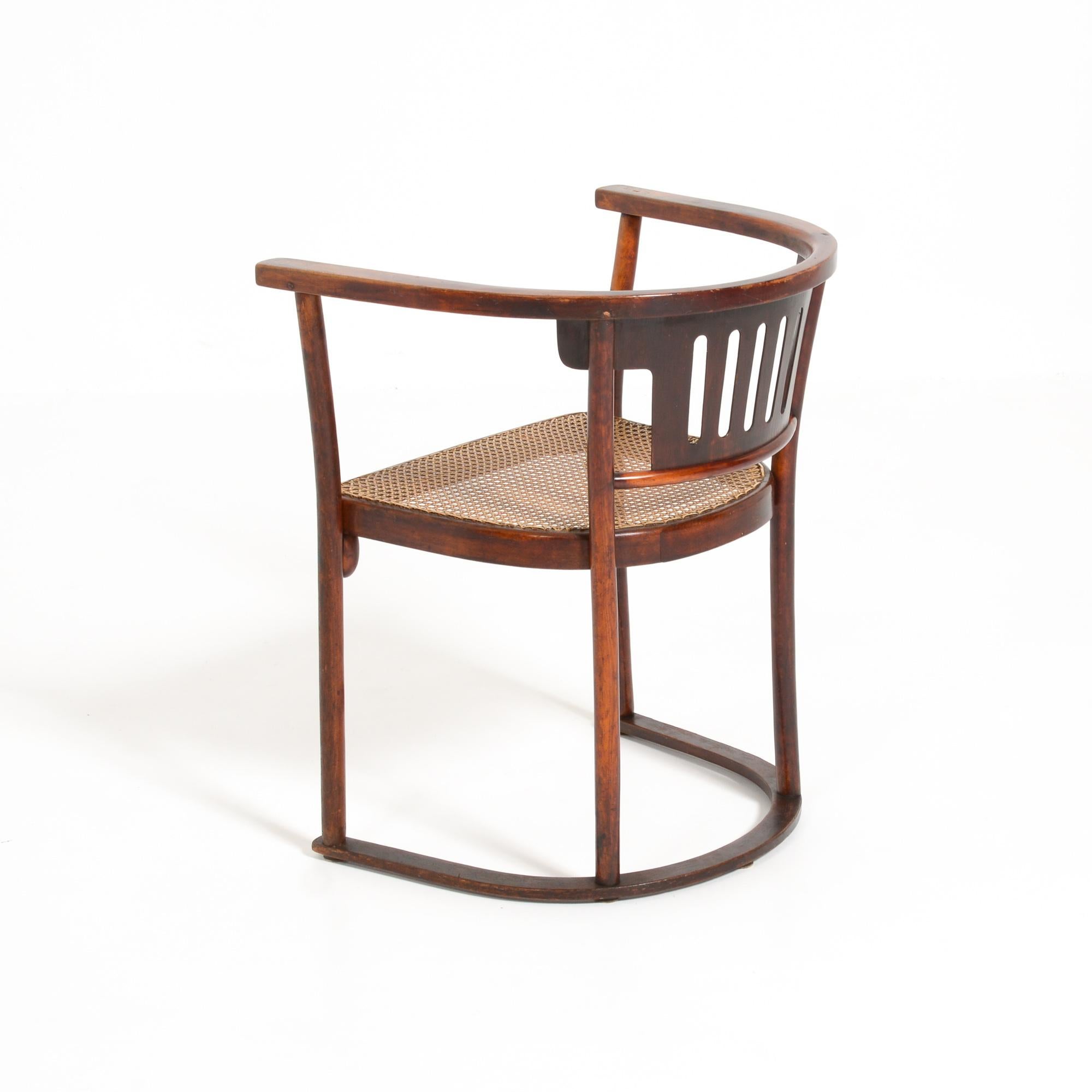 This armchair was designed by Josef Hoffmann for Thonet in the early 20th century.
It is a beautifully shaped chair with egg shaped details under the seat. The seat was renewed in the 1970s with a faux cane webbing.
This chair is in good authentic