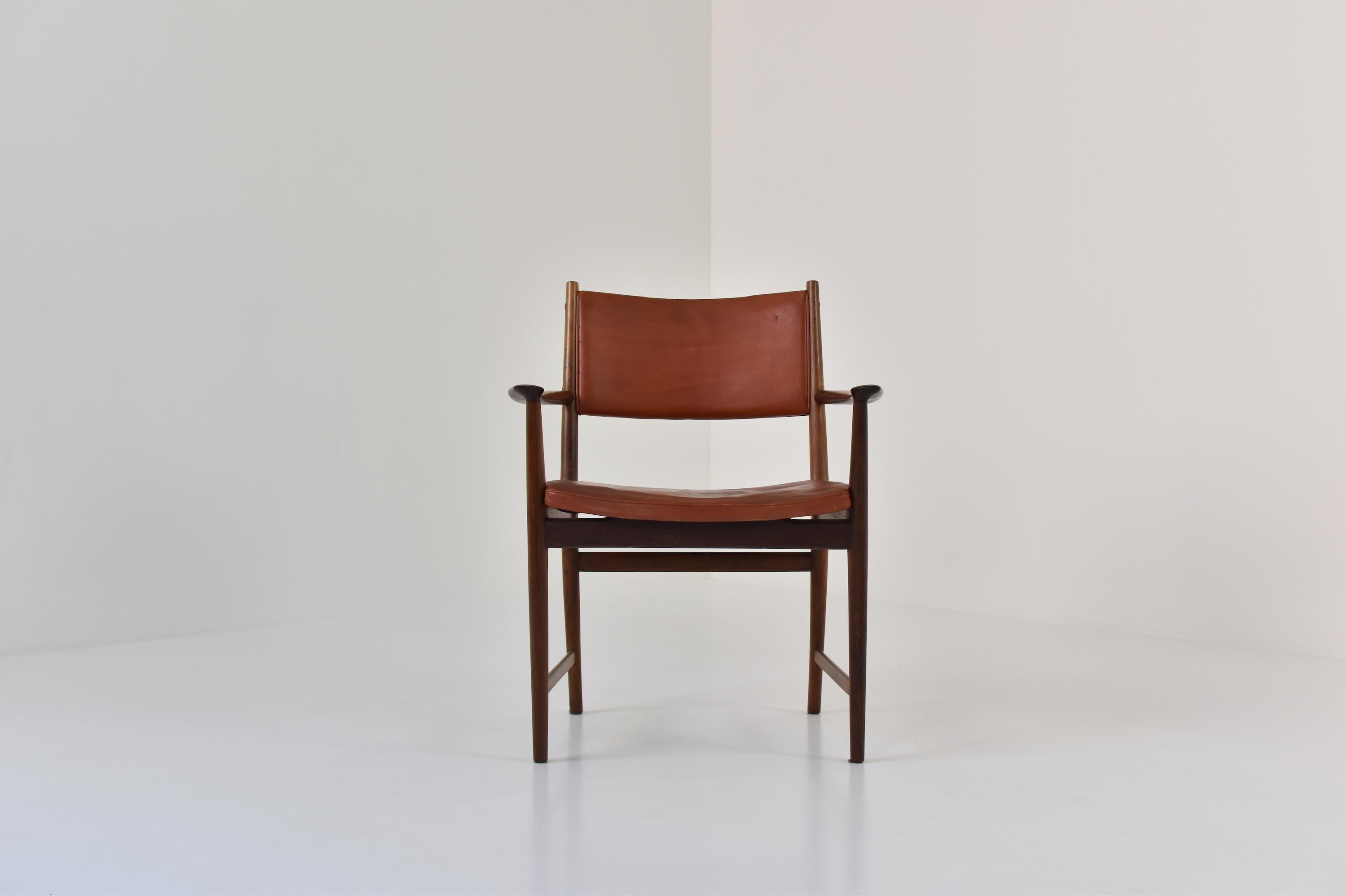 Gorgeous armchair designed by Kai Lyngfeldt Larsen for Søren Willadsen Møbelfabrik, Denmark, 1950s. This chair features a rosewood frame and the original brown leather upholstery. Great patina. Labeled underneath.