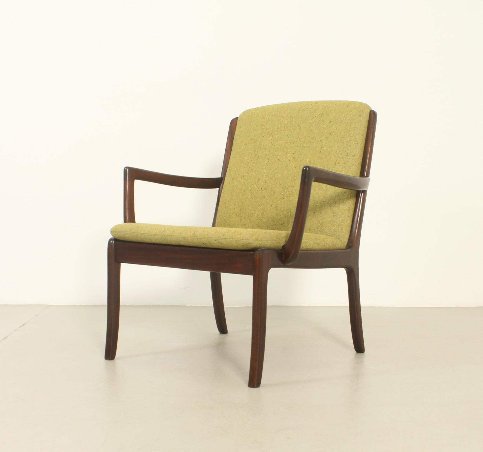 Armchair designed in 1960's by Ole Wanscher for Cado, Denmark. Structure in teak wood with original upholstery in wool fabric.