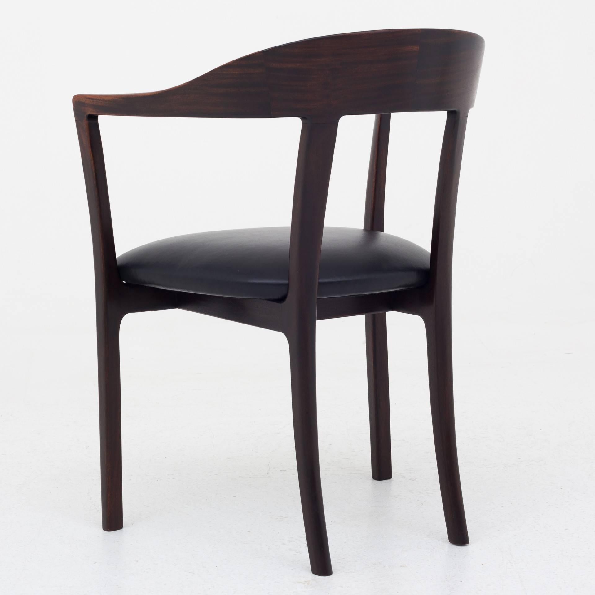 J 2833, armchair in stained mahogany, reupholstered seat in black canyon leather. Designed in 1958. Maker A. J. Iversen.