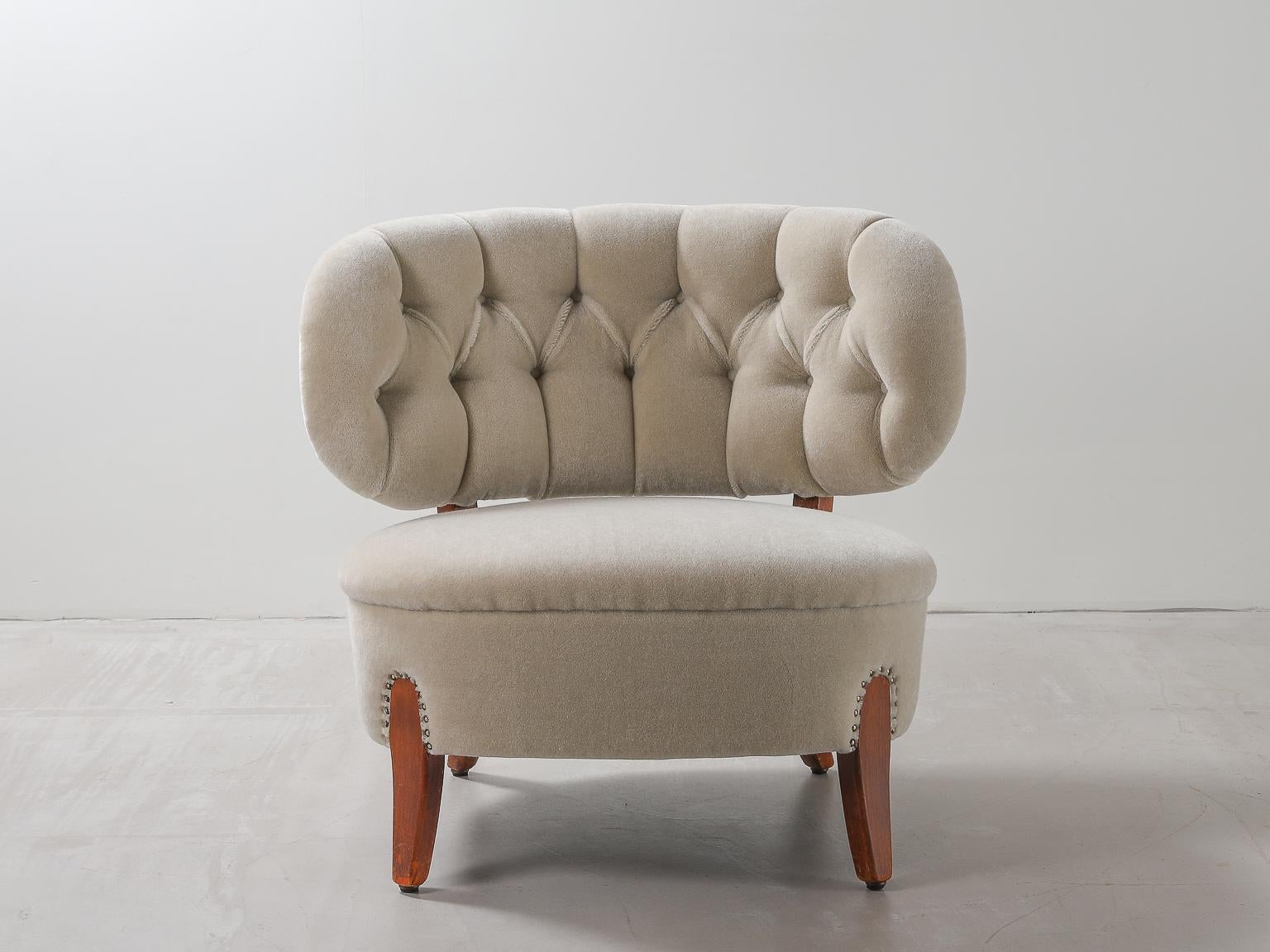 The lounge chair designed by Otto Schulz in 1936 & manufactured from the 1940s. Newly upholstered in bespoke mohair velvet bespoke by Thurstan with deep button back details & antique brass ball studs.

Otto Schulz (1882-1970)
Schulz was born in