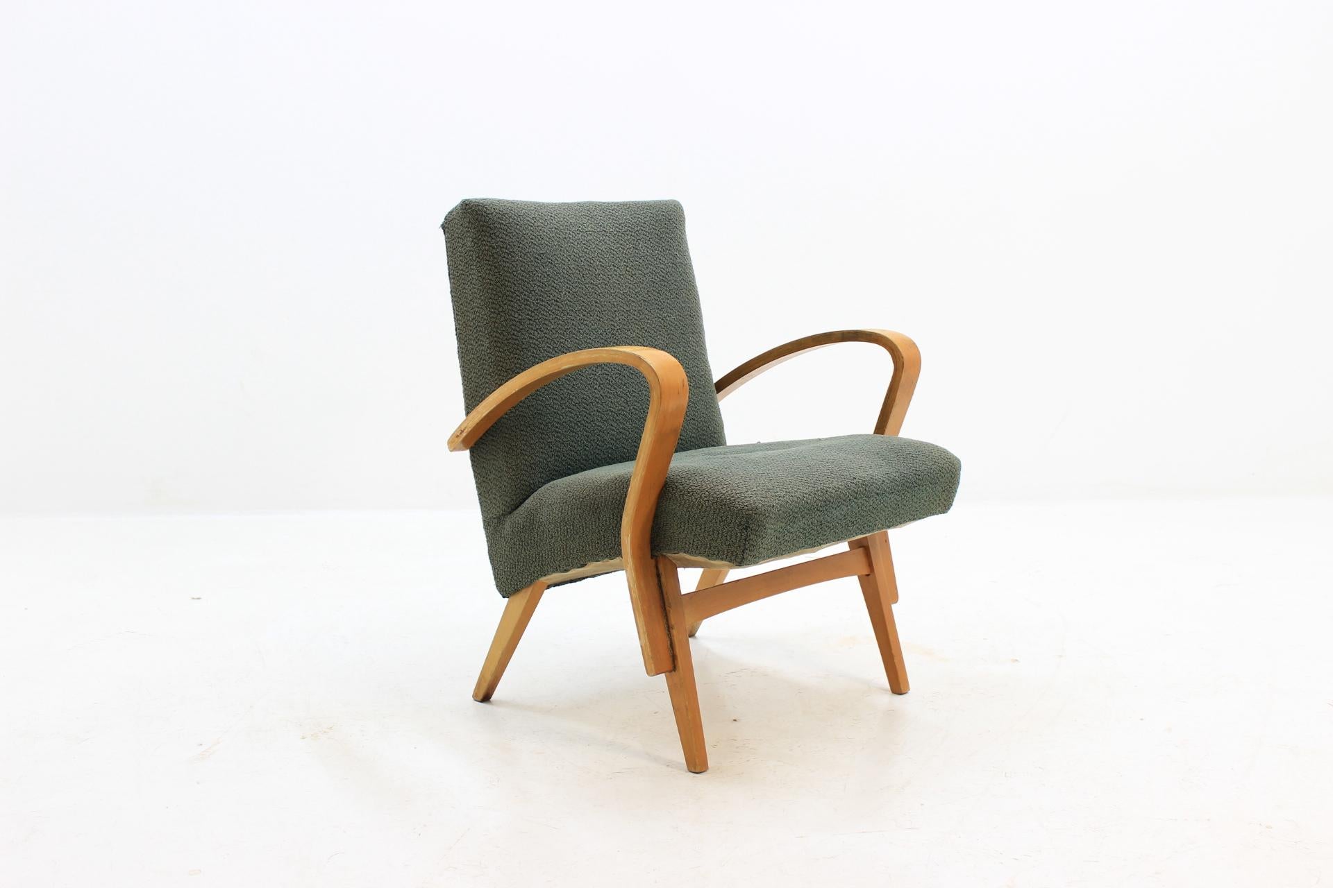The item made of oak wood. On upholstery are vestige from of normal use. Manufacturer is Tatra Pravenec in Czechoslovakia. Armchair is in original condition.