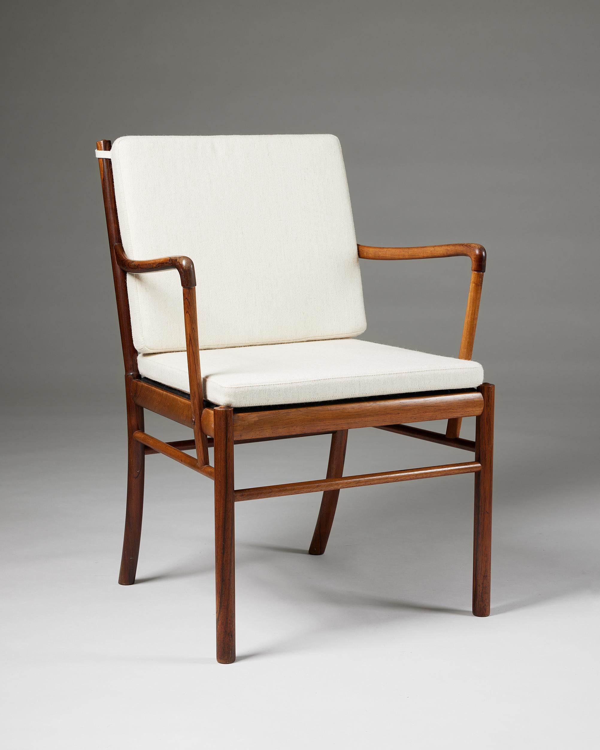 Armchair ‘Colonial’ designed by Ole Wanscher for Poul Jeppesen,
Denmark, 1949.

Savak wool upholstery and rosewood.

Marked.

H: 86.5 cm / 2' 10''
W: 63.5 cm / 2' 1''
D: 59 cm / 23 1/4''
SH: 47.5 cm / 18 3/4''
AH: 68 cm / 2' 2 3/4''.