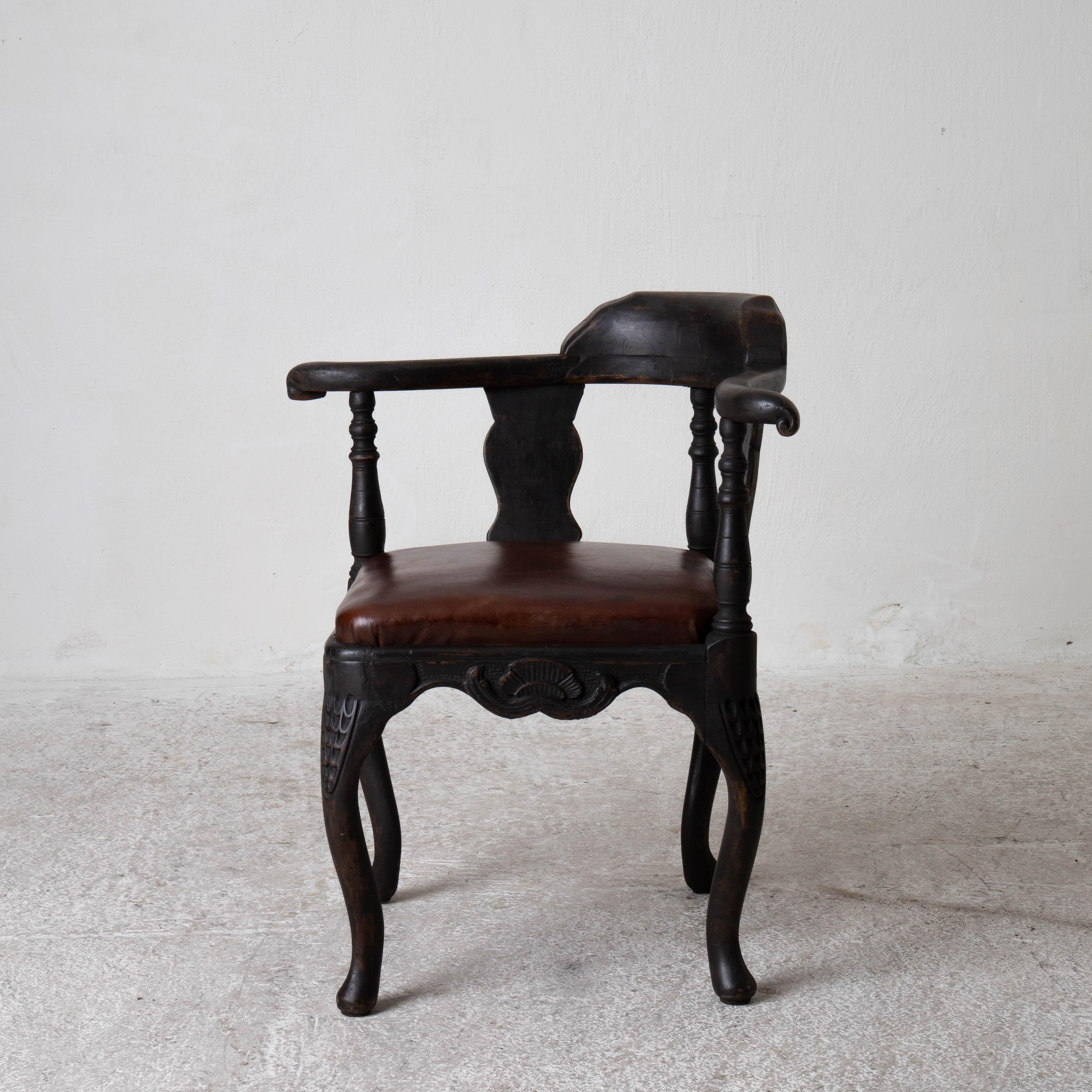 Armchair Corner Swedish Black Rococo Sweden. A corner chair made during the Rococo period 1750-1775 in Sweden. Refinished in our Laserow Black. Upholstered in a dark brown leather.

 