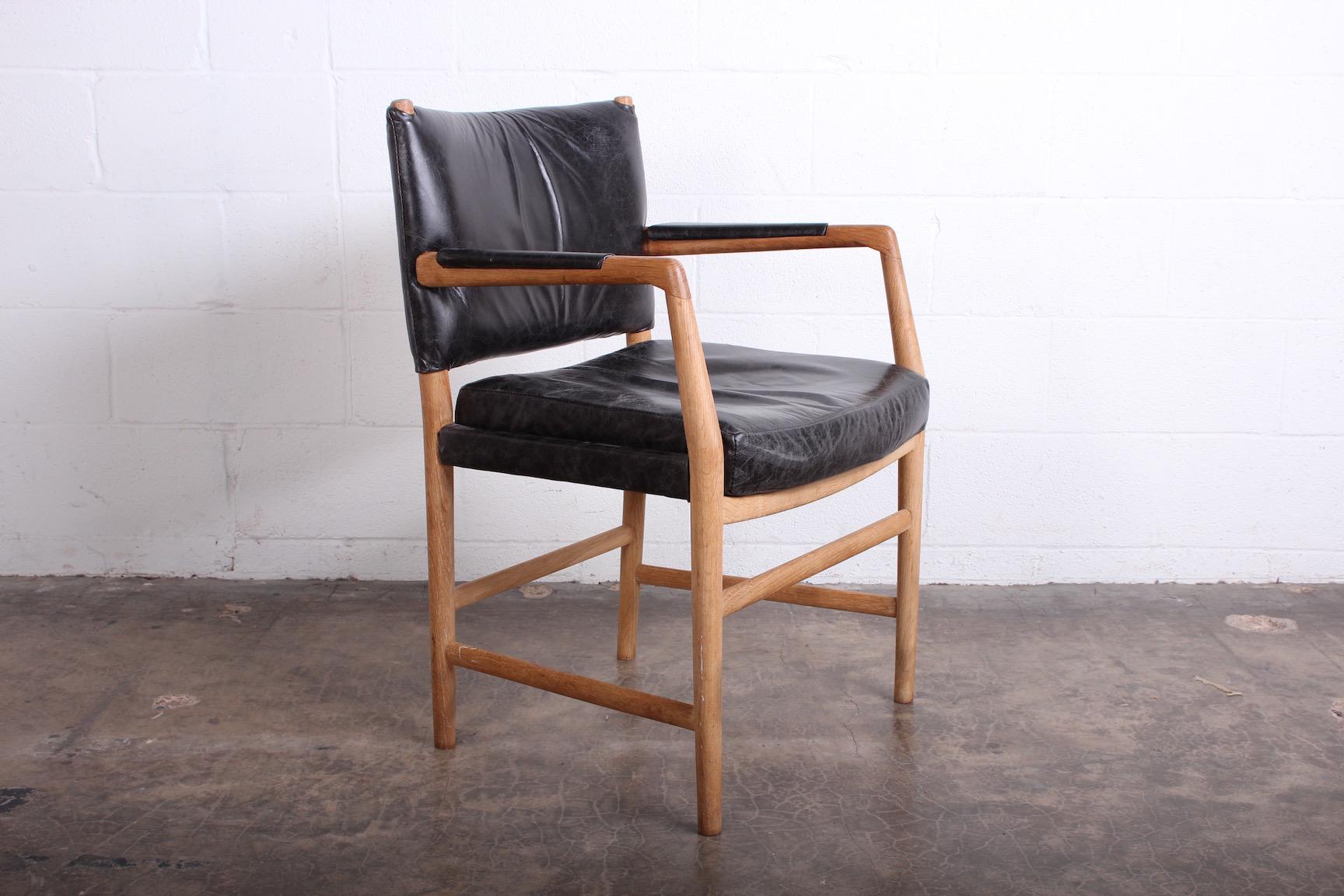 A leather and oak armchair designed by Hans Wegner.