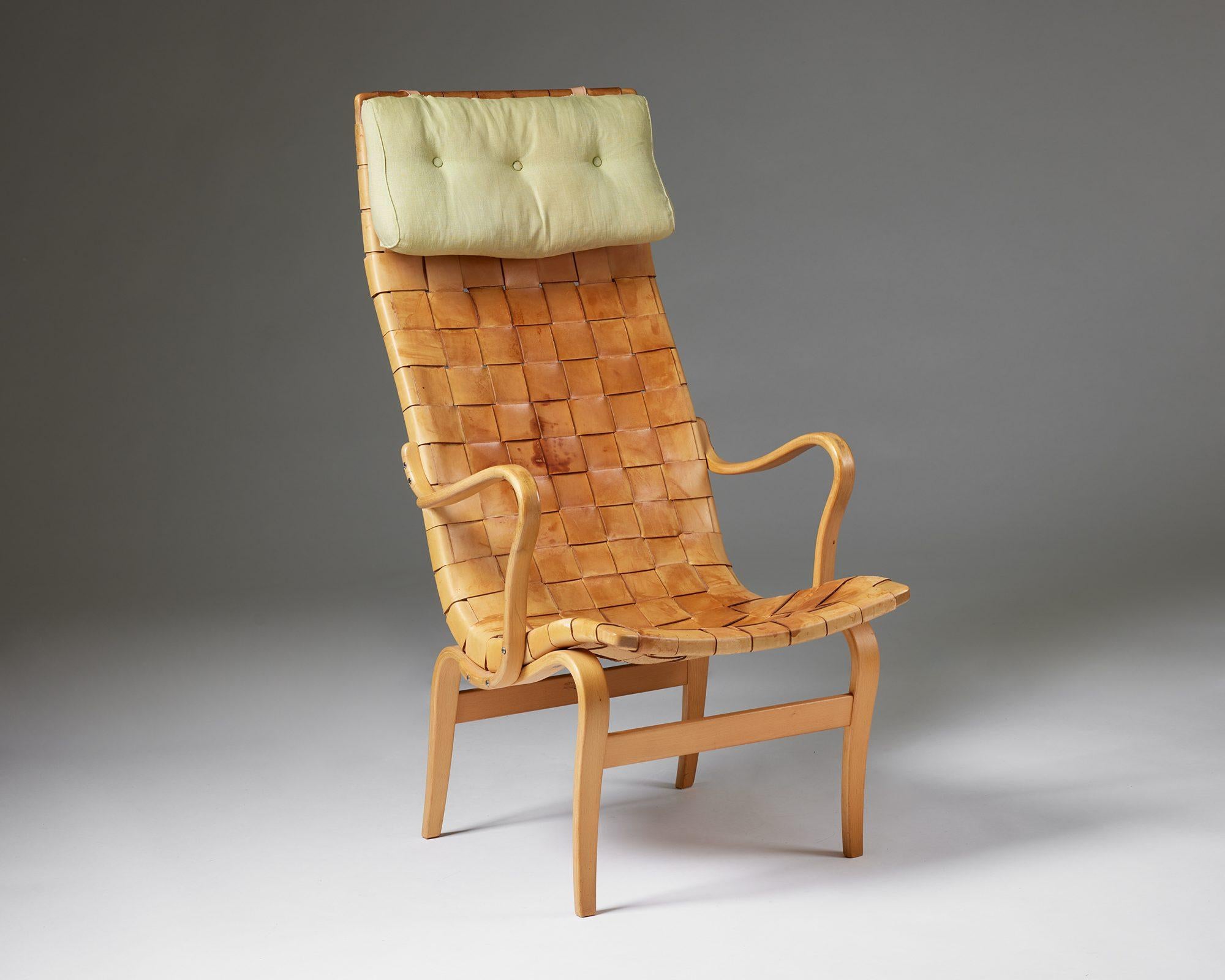 Armchair ‘Eva High’ designed by Bruno Mathsson for Karl Mathsson, 
Sweden, 1960.

Birch framing, braided leather upholstery and a textile neck pillow.

Stamped.

Measurements: 
H: 110 cm / 3' 7 1/4''
W: 60 cm / 23 1/2''
D: 73 cm / 2' 4 3/4''
SH: 35