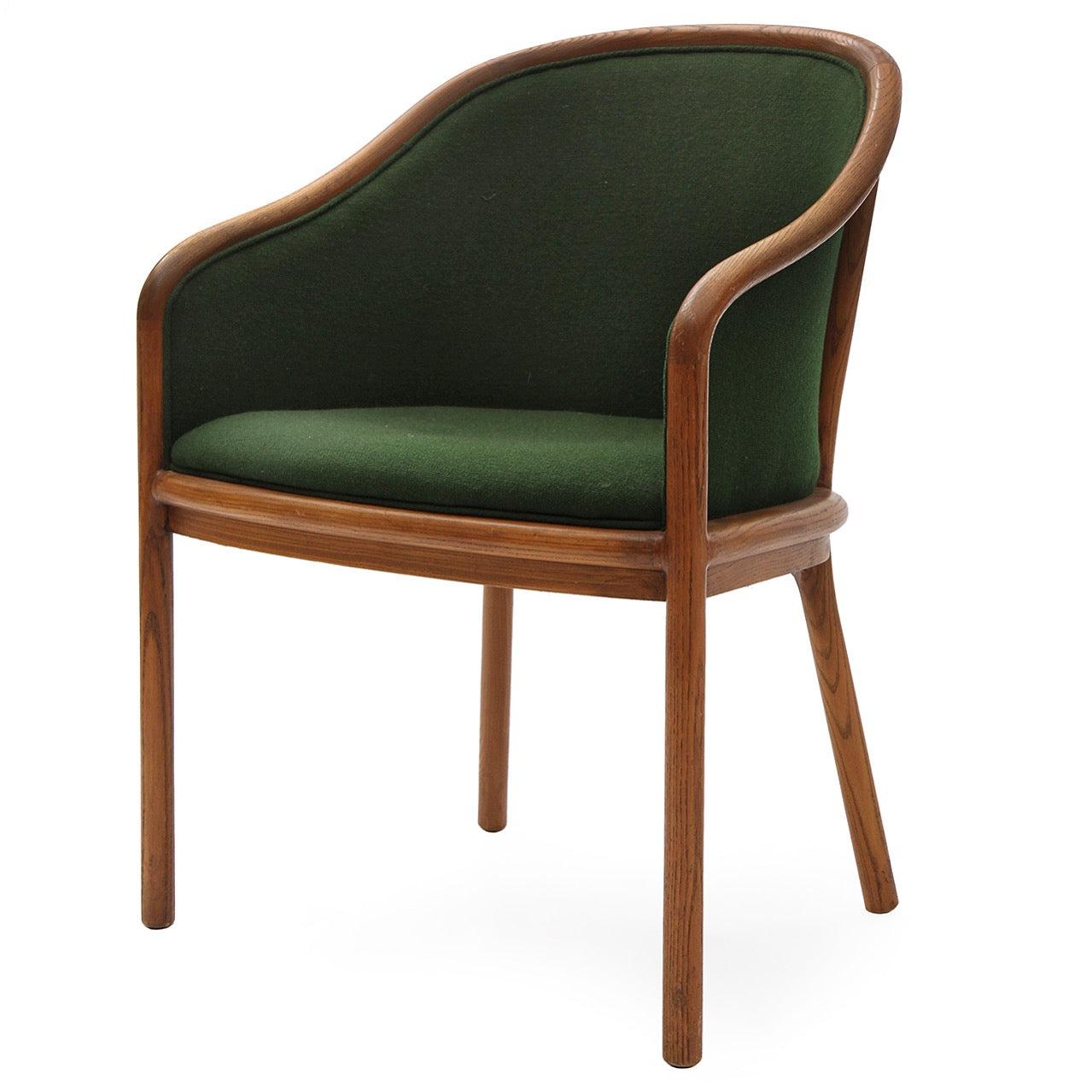 An elegant and comfortable arm chair having a fluid and bold ash frame seamlessly encasing a seat upholstered in vintage green wool fabric. Upholstery required, inquire for options.
