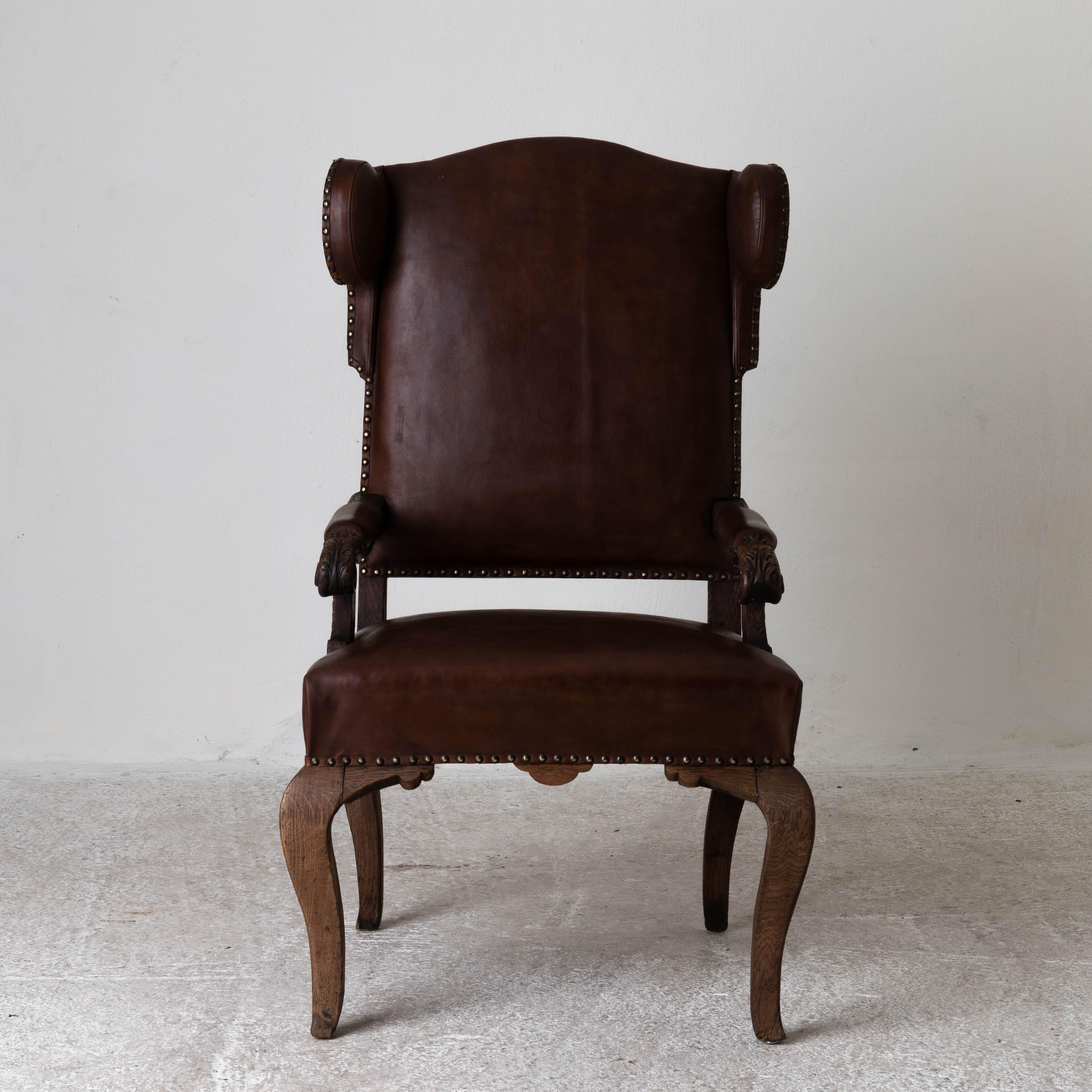 Chaise française Wingback Période rococo France. Chaise à oreilles fabriquée pendant la période rococo en France de 1720 à 1750. Finition originale et rembourrage en cuir brun ciré. 

Mesures : H : 47.8

W : 25