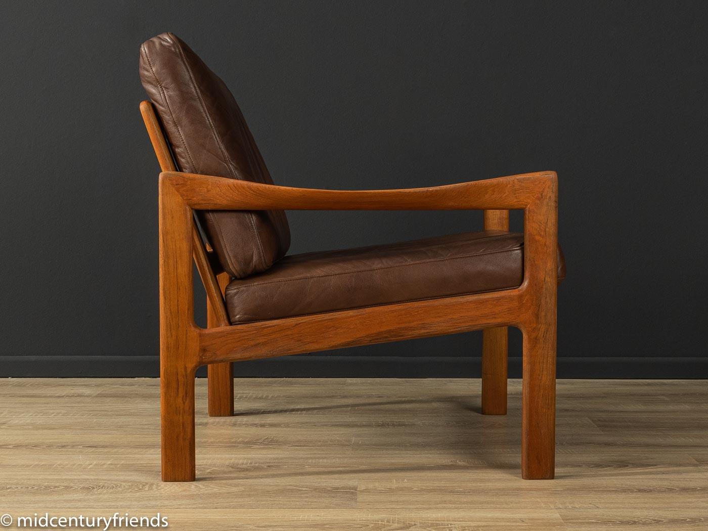 Classic armchair from the 1960s. High-quality frame made of solid teak with the high-quality original leather cover in brown.

Quality Features:
- accomplished design: perfect proportions and visible attention to detail
- high-quality