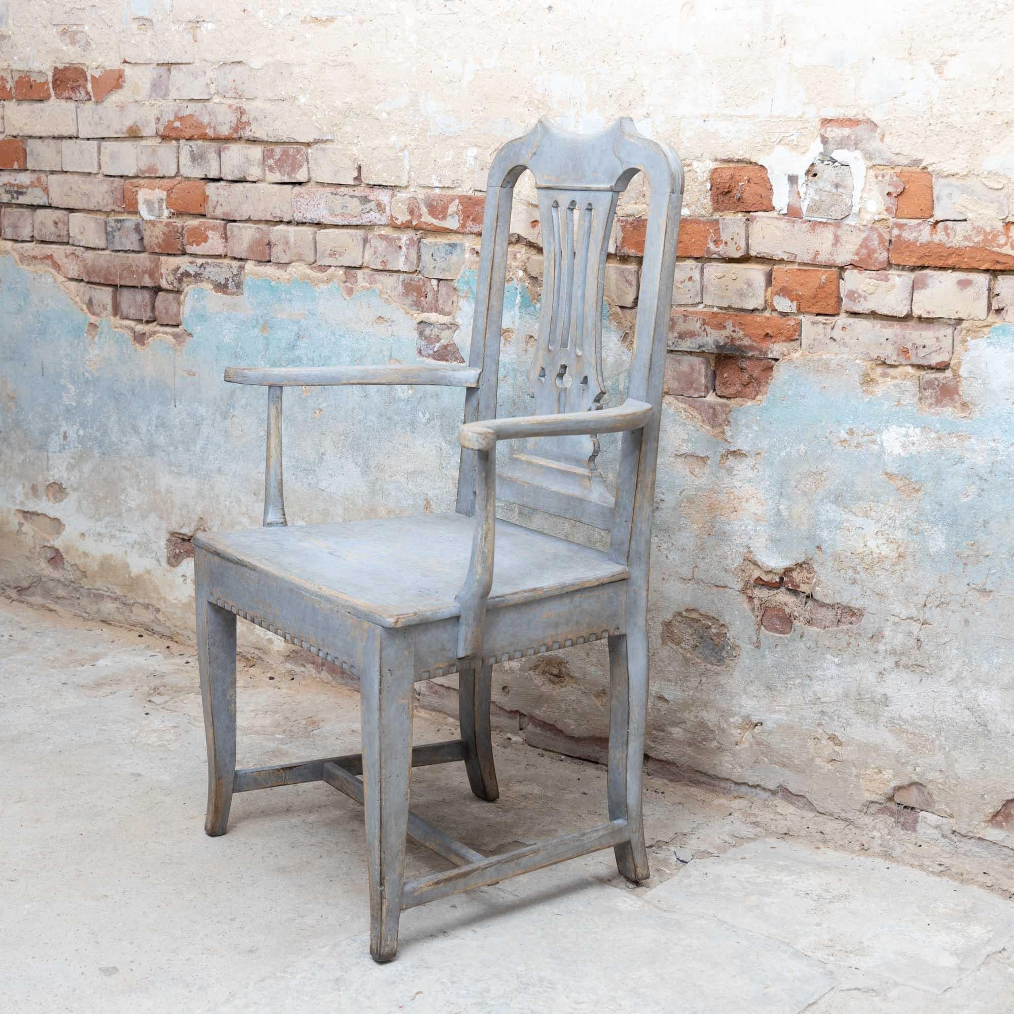 Armchair with rounded backrest with lyre-shaped central bar and tooth cut on the front frame. The frame in grey-blue is new and has been decoratively patinated.