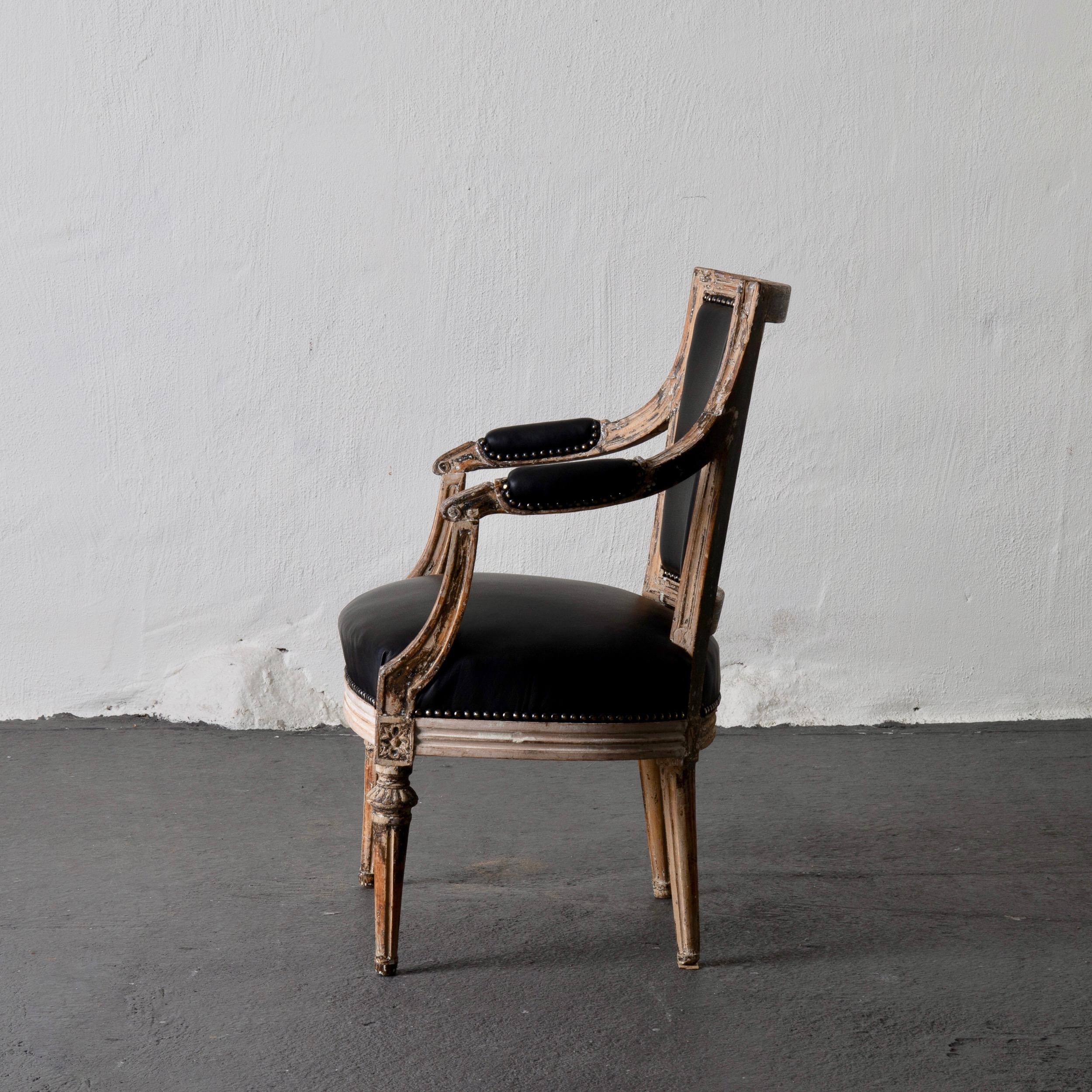 An armchair made during the Gustavian period in Sweden 1790-1810. Stripped and upholstered in a soft black leather. Channeled legs. 

  