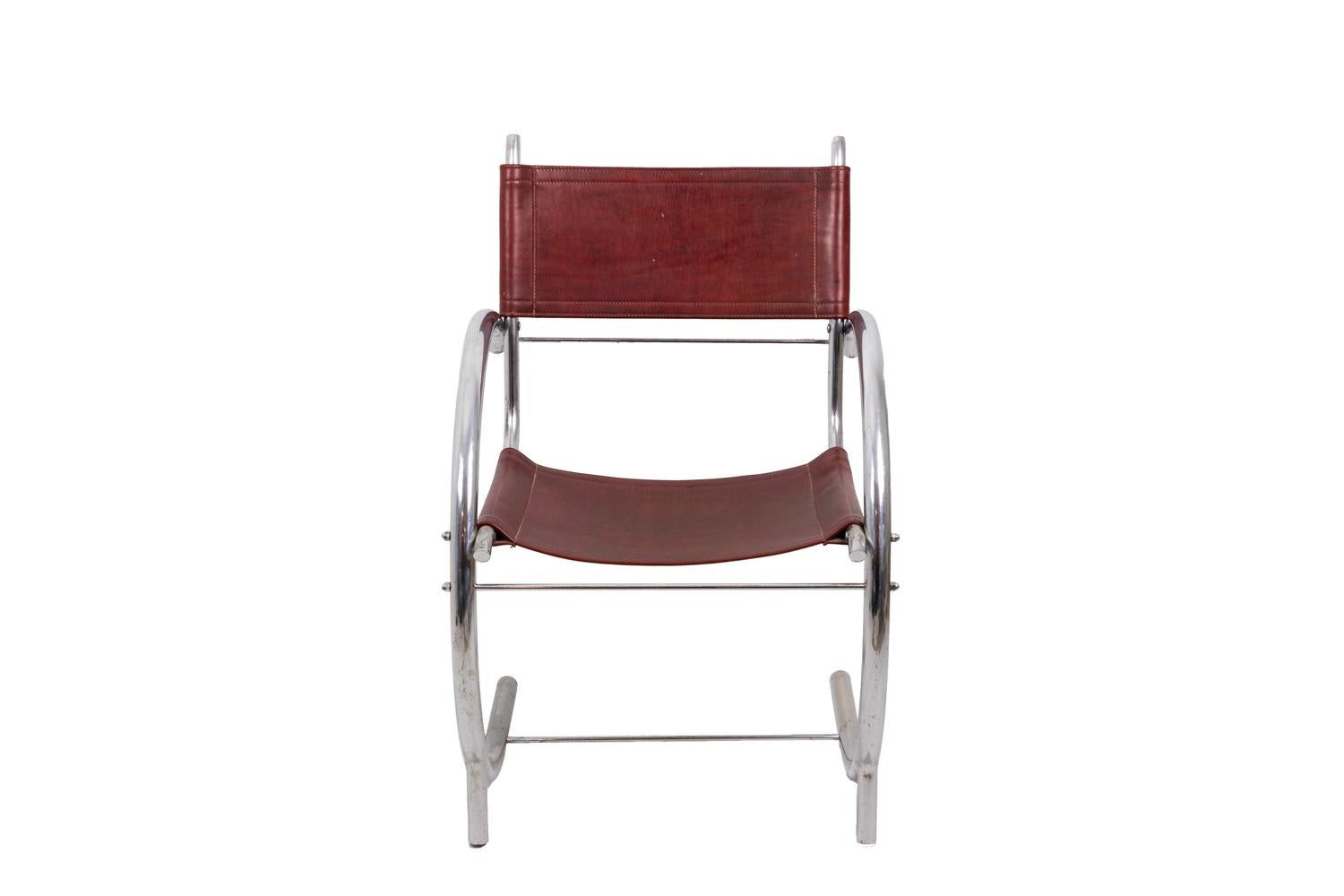 Armchair in chromed metal with legs and arms forming a half-circle. Legs linked with each other by a stick stretcher. Rectangular shape red leather seat and back.

Work realized in the 1930s.