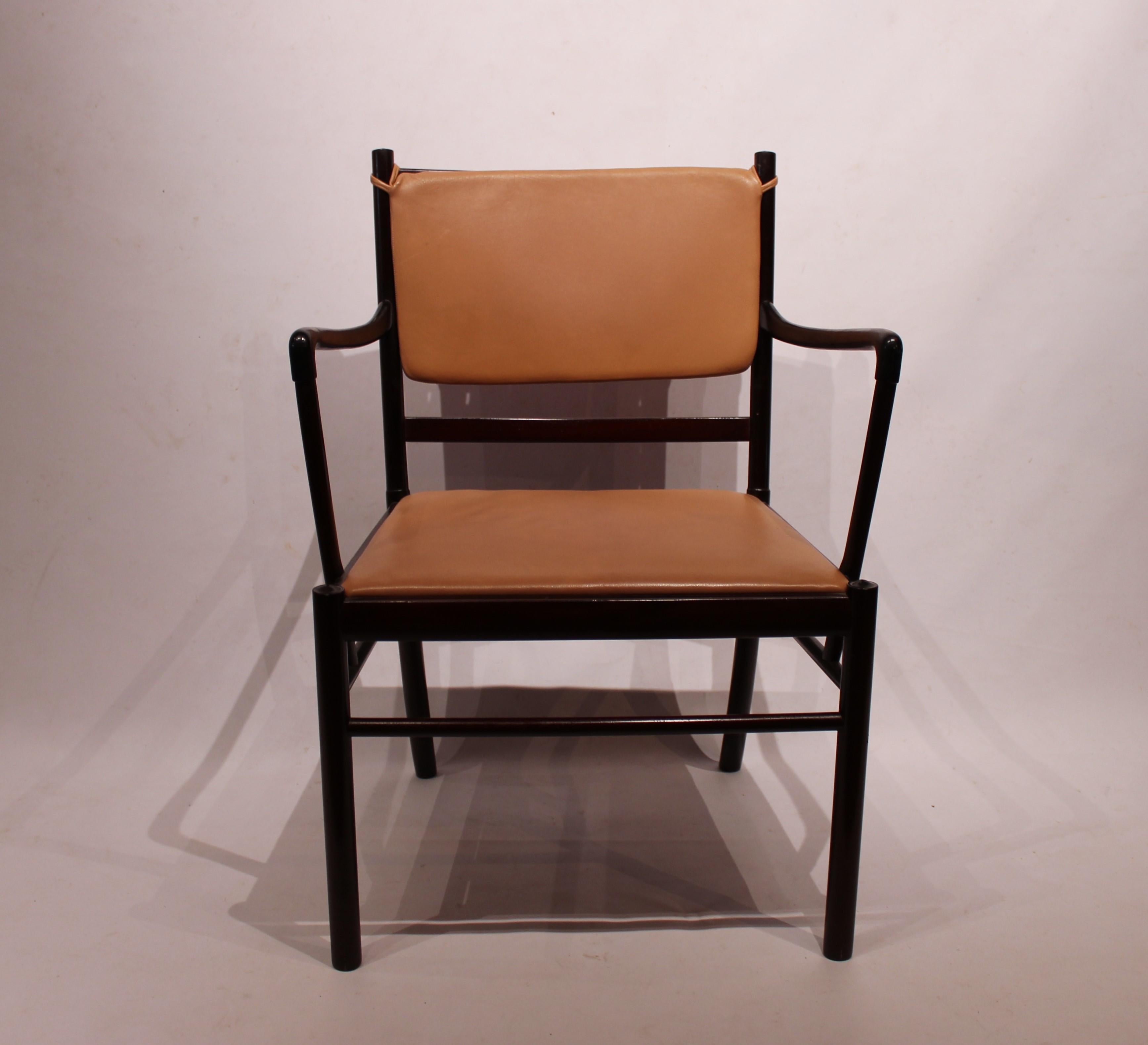 Armchair in mahogany and light brown leather designed by Ole Wanscher and manufactured by P. Jeppesen. The chair is in great vintage condition.