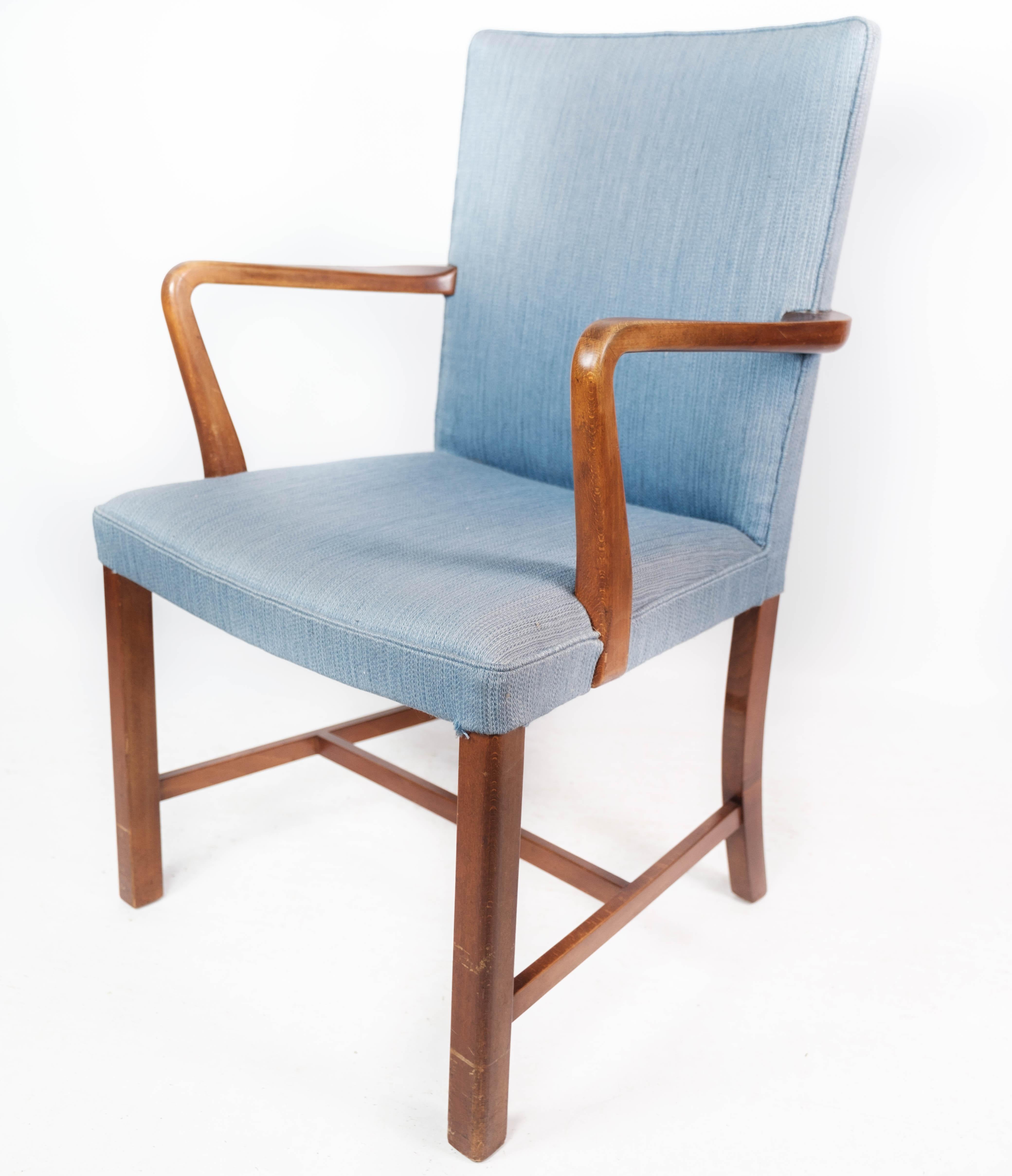 Armchair in mahogany and upholstered with light blue fabric by Fritz Hansen. The chair is in great vintage condition.