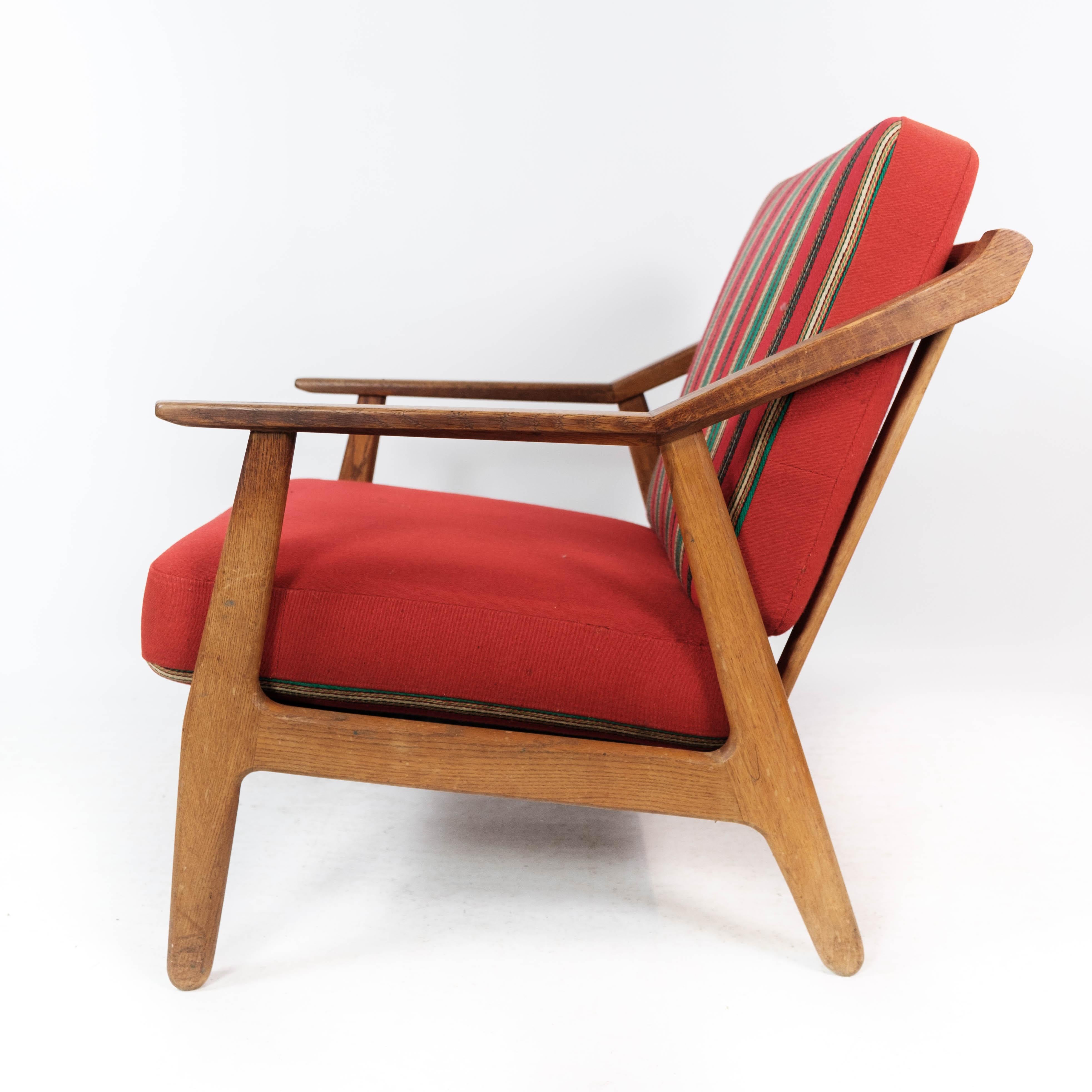 Danish Armchair in Oak and Upholstered with Red Fabric, by H. Brockmann Petersen, 1960s For Sale