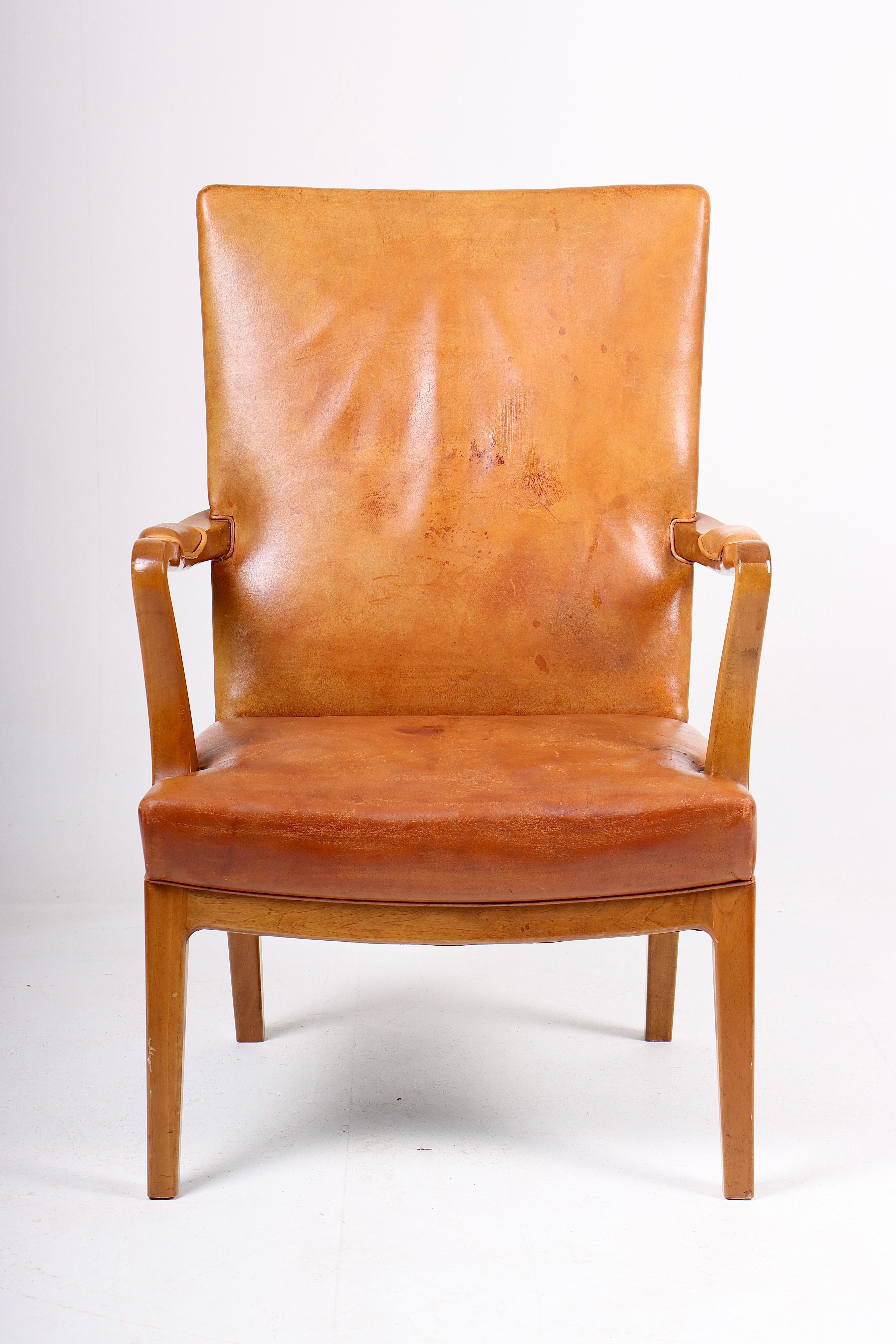 Armchair in patinated leather, made by Lysberg Hansen & Terp in 1940s. Made in Denmark. Great condition.