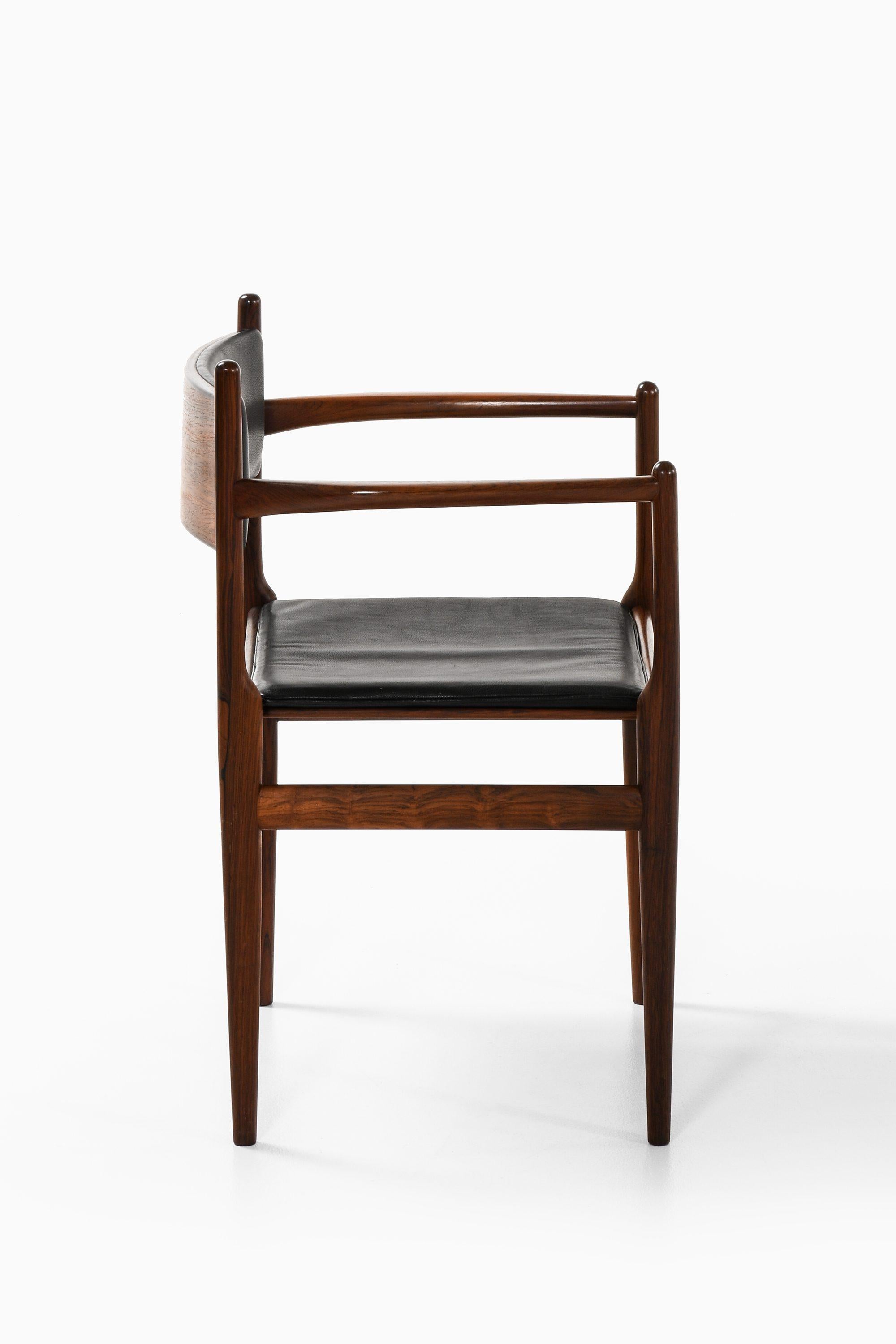 Danish Armchair in Rosewood and Black Leather by Kai Lyngfeldt Larsen, 1960's For Sale