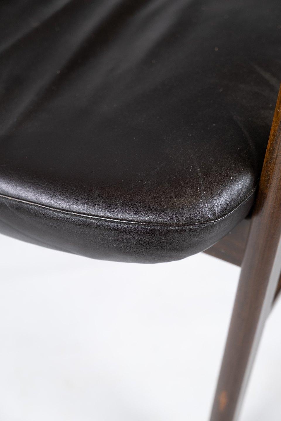 Armchair in rosewood and black leather of Danish design from 1976. The armchair is in great vintage condition.