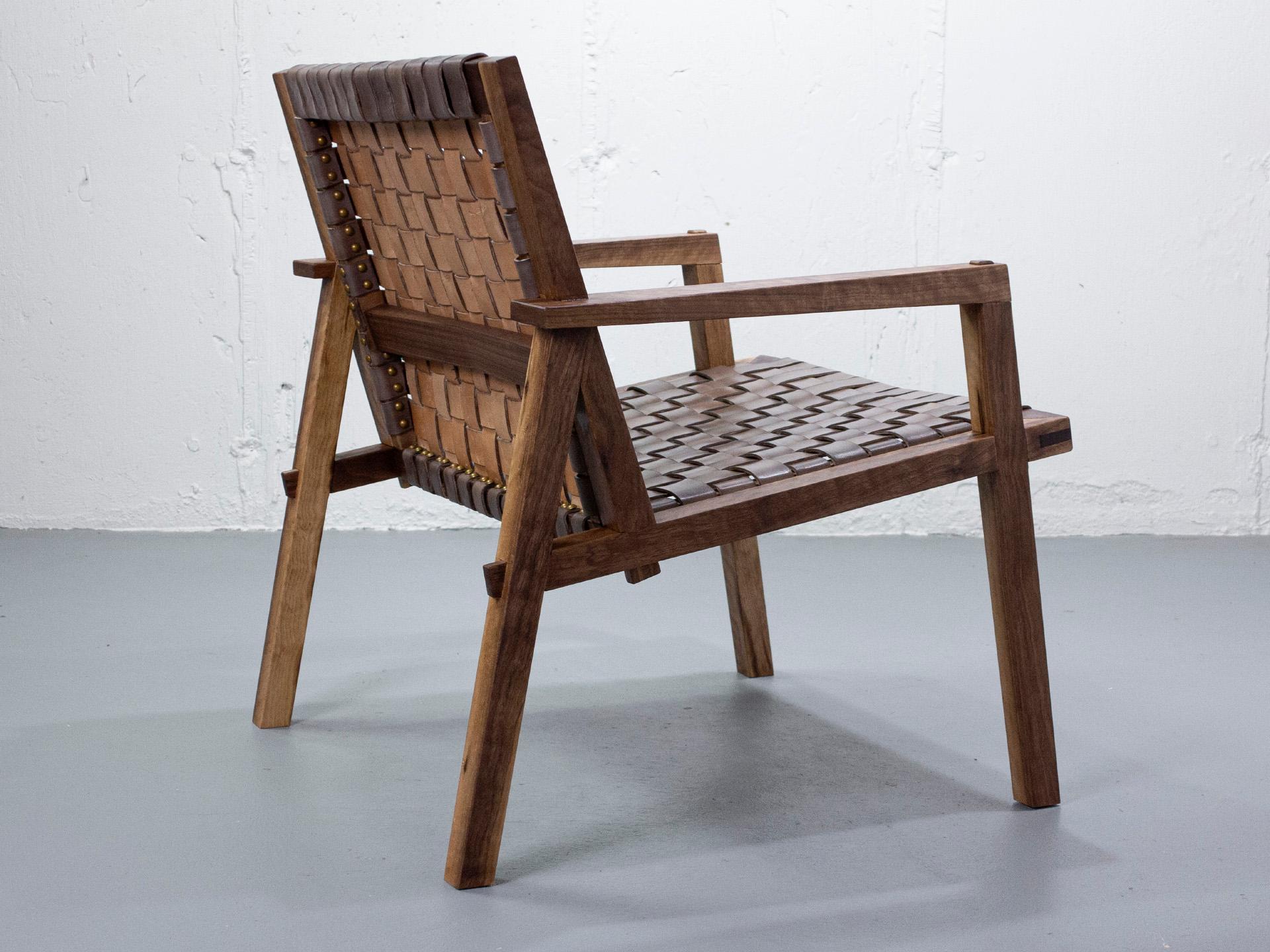 Minimalist ARMCHAIR in solid black walnut with vegetable tanned leather webbing. For Sale