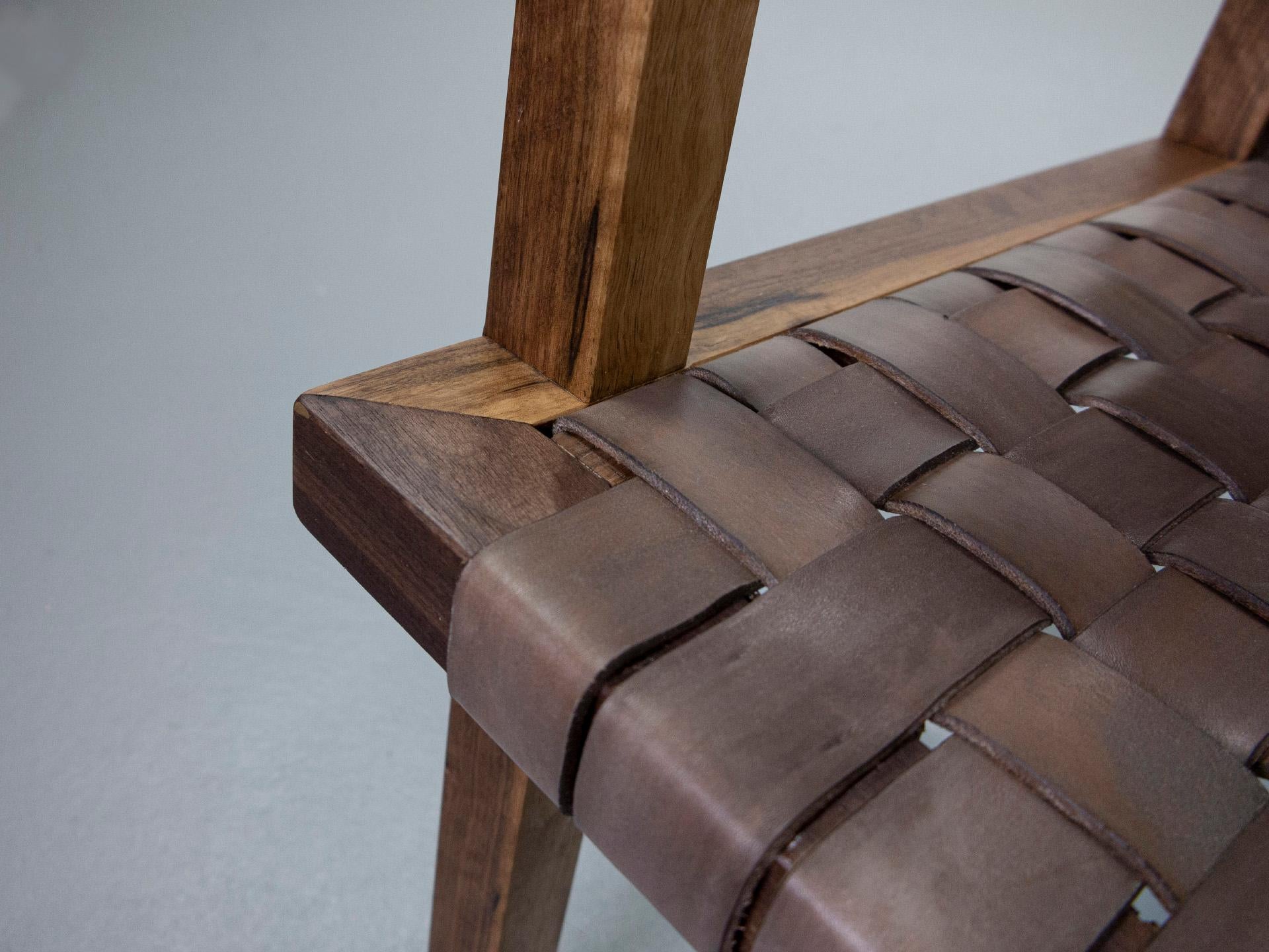 Contemporary ARMCHAIR in solid black walnut with vegetable tanned leather webbing. For Sale