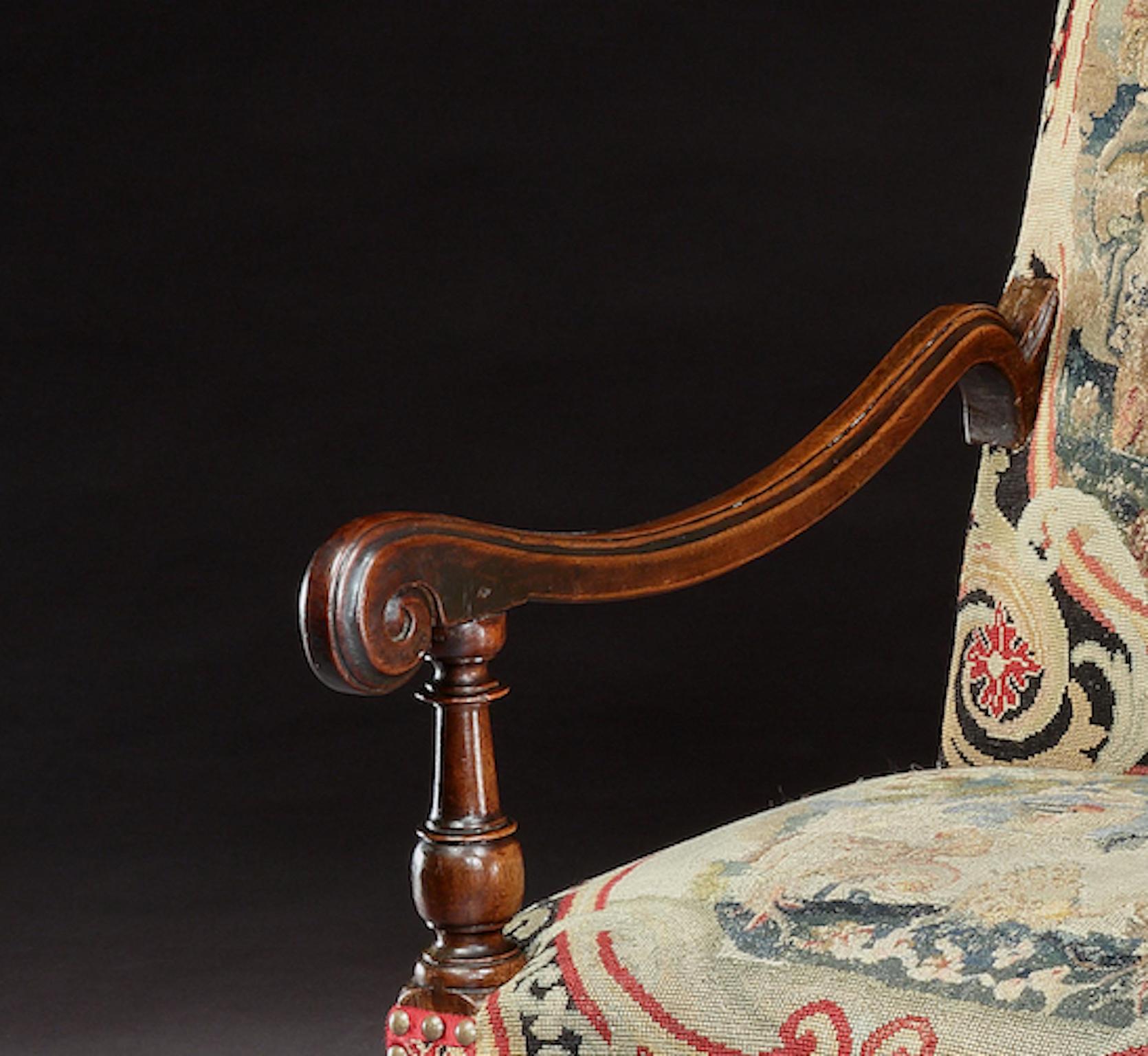 An exceptional, museum quality, English, baroque, walnut, open armchair with faceted legs and shaped ‘x’ stretcher, upholstered in fine Georgian needlework with 19th century needlework borders


Faceted front and back legs are only found on the