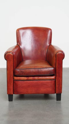 Fauteuil en cuir de mouton de couleur rouge/brun
