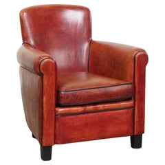 Armchair made of sheepskin leather in a red/brown color