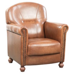 Armchair made of sheepskin leather with refined decorative nail finish