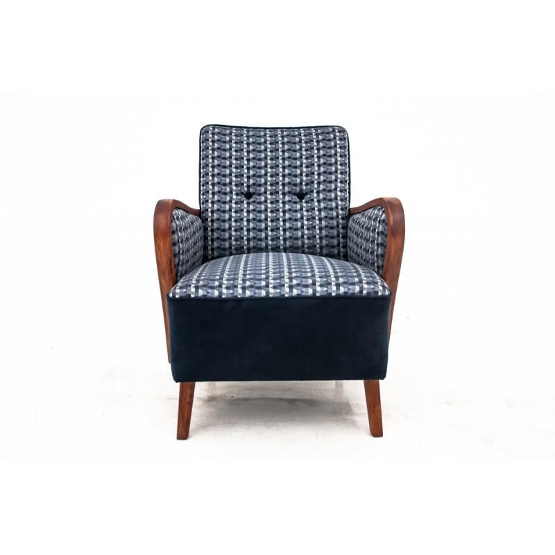 The armchair comes from Poland from the 1960s. The construction was made of walnut wood. The armchair is after renovation of wood, it has new, dark blue upholstery.