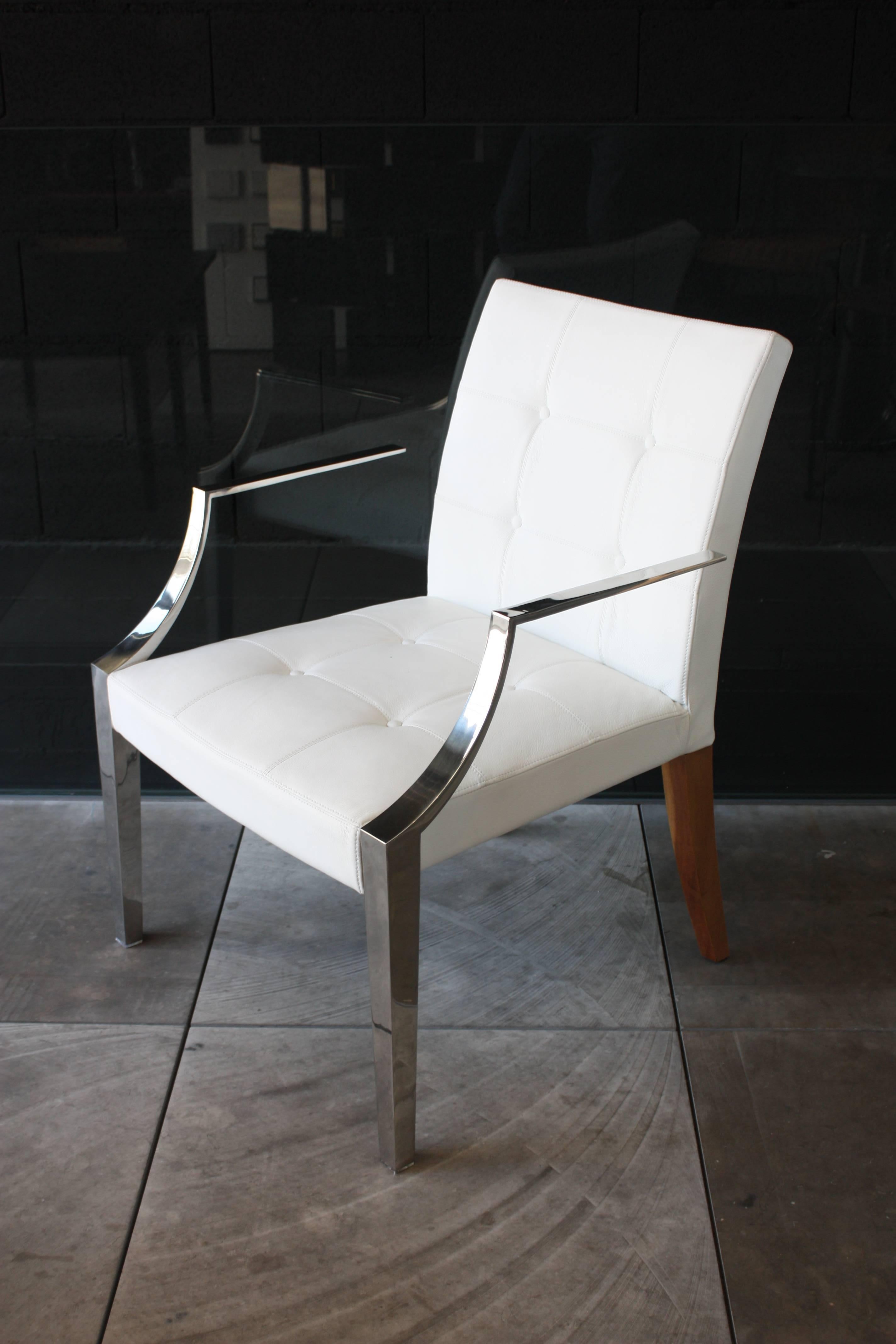 Armchair Monseigneur designed by Philippe Starck for Driade, Italy. Structure with front legs/armrests in stainless steel casting and back legs in mahogany wood, seat and back in polyurethane foams with fixed cover in quilted white leather.