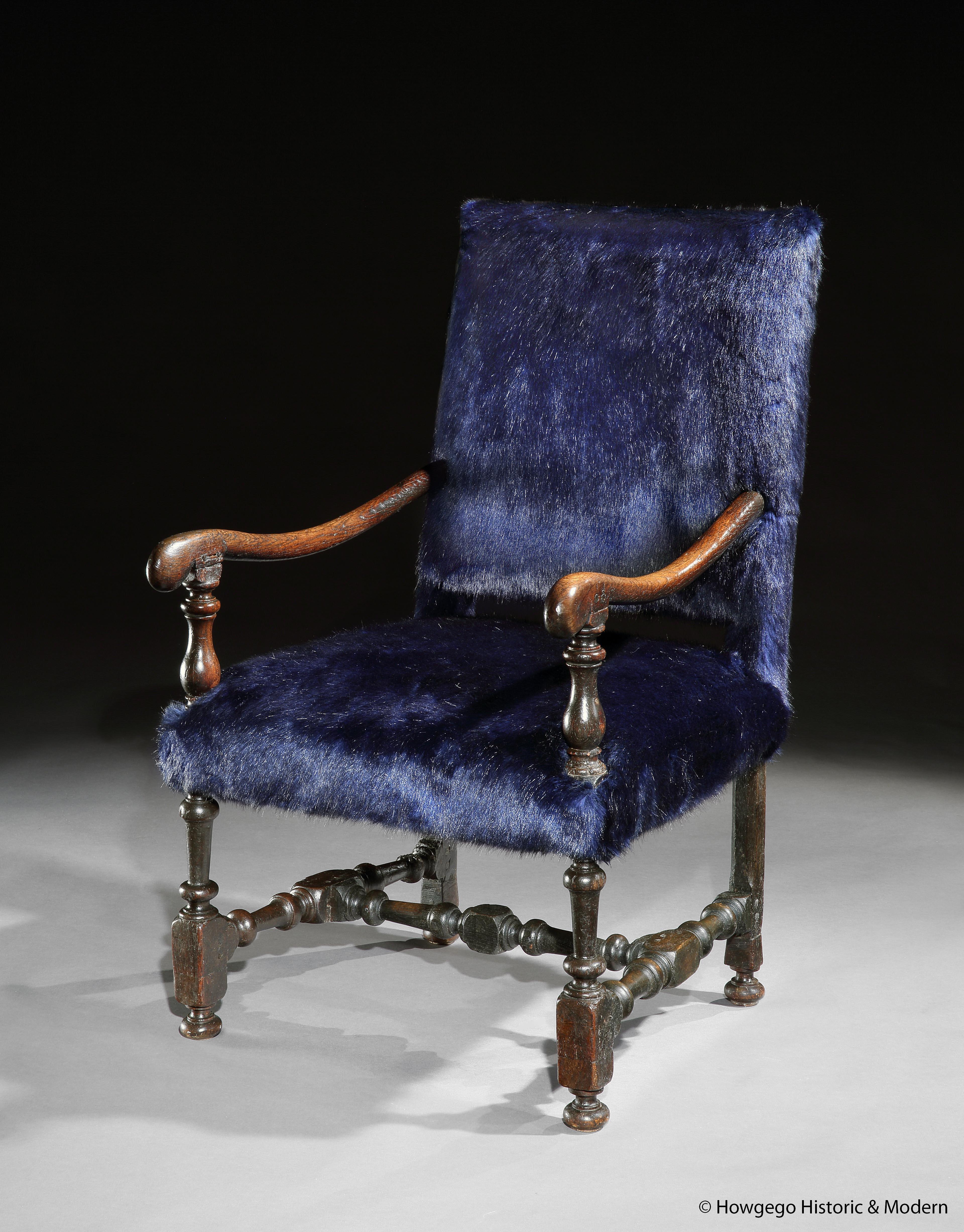 17th century oak armchair re-upholstered in navy faux faur

The faux fur creates a cosy, funky, fun, modern, individual, interpretation of a classic 17th century armchair
It also injects a baronial character to the armchair
The chair has