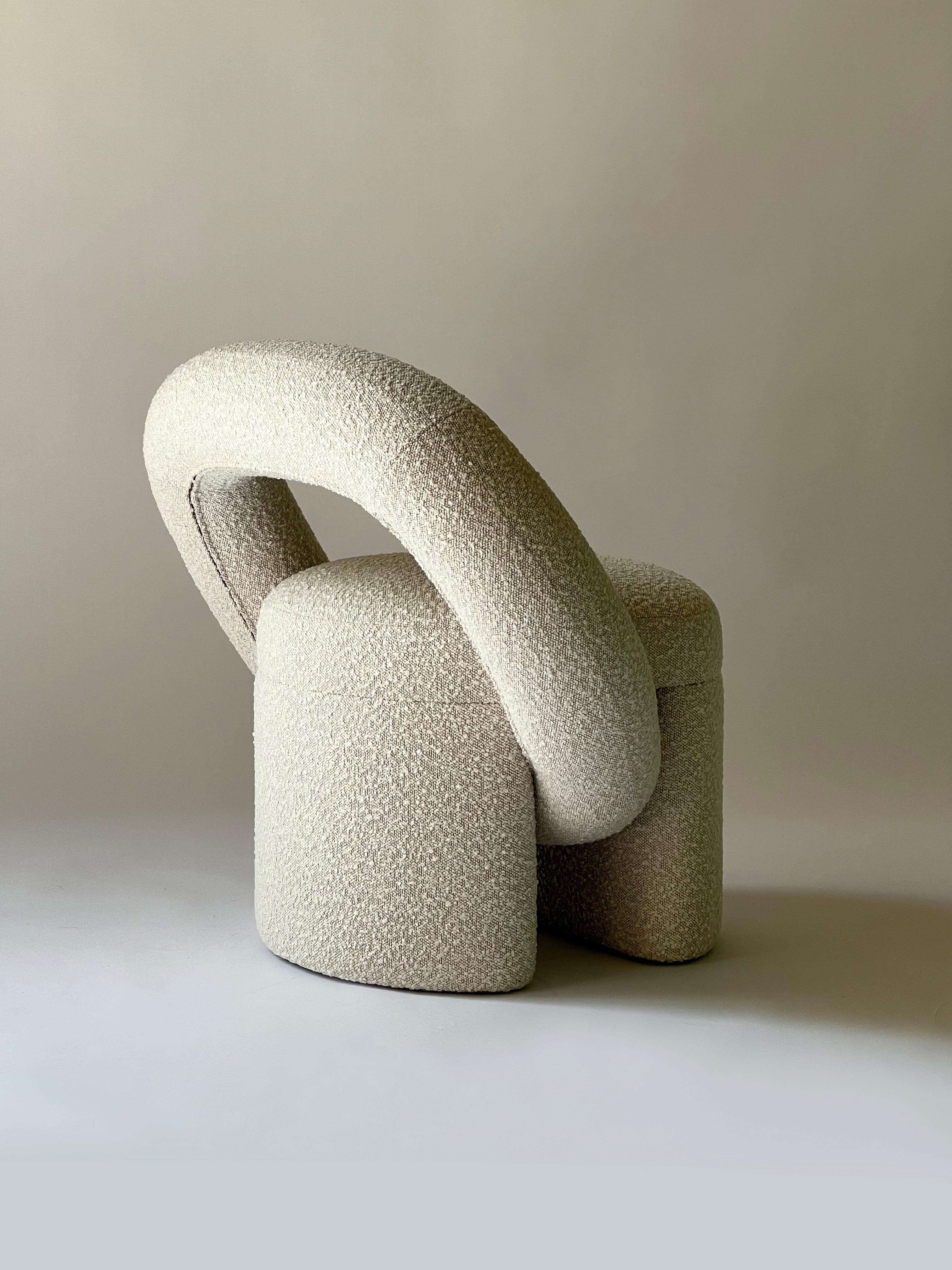 “PLAY” armchair has an unusual shape that was assembled from several geometric elements. The bagel-shaped detail serves the back of the chair.
Handcrafted in Ukraine, this armchair embodies the perfect blend of comfort and style. Its sleek design