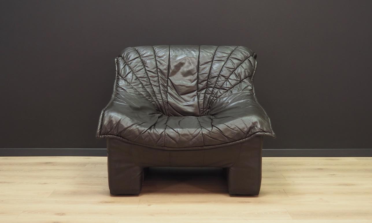 Fantastic armchair from the 1960s-1970s, manufactured in the VIVA factory. Upholstery made of original leather, in very dark brown. However, in faded light they look black. Maintained in good condition (minor bruises and scratches), directly for