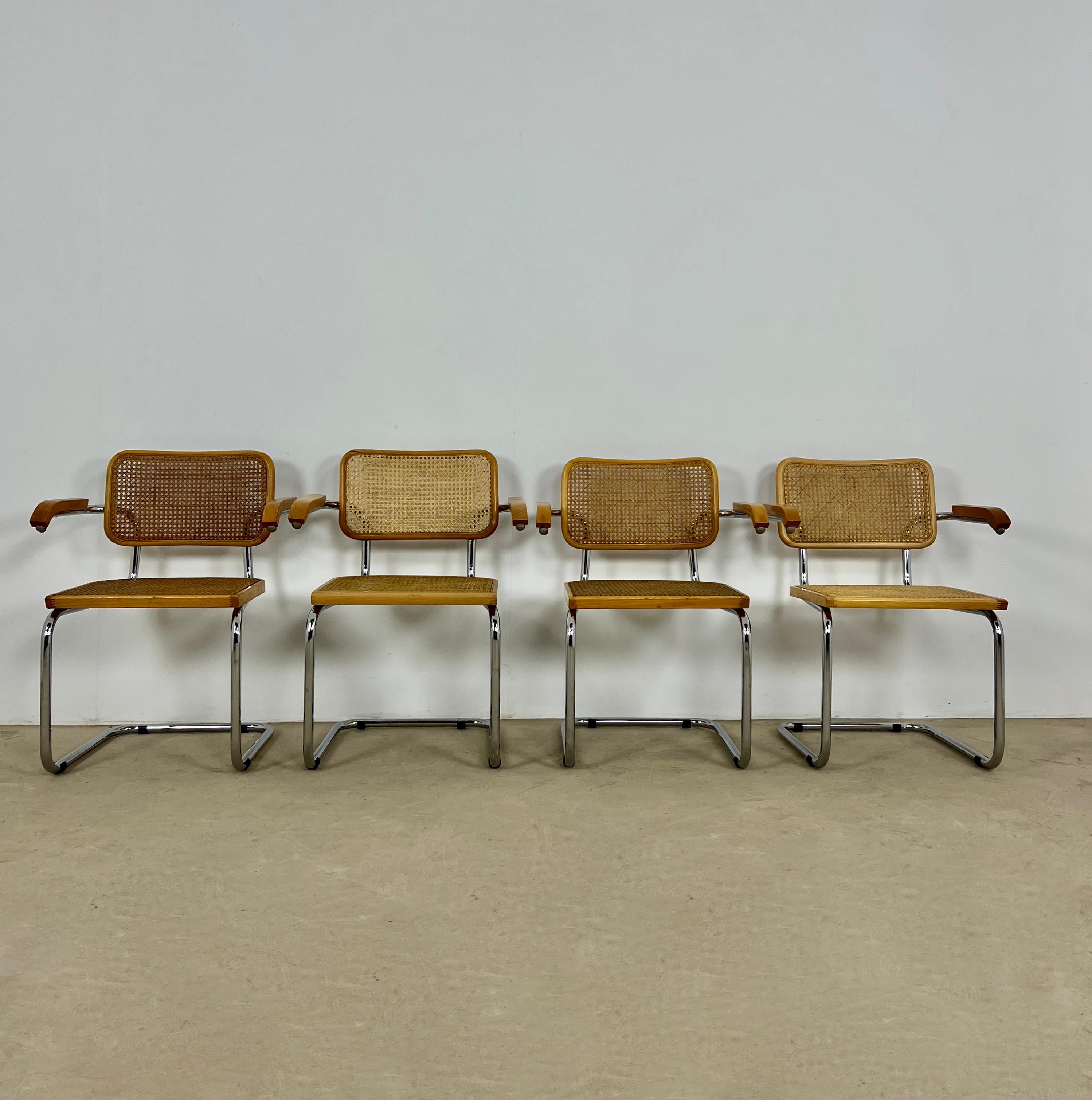 Series of 4 armchairs in wood, metal and cane. Wear due to time and age of the chairs.
       