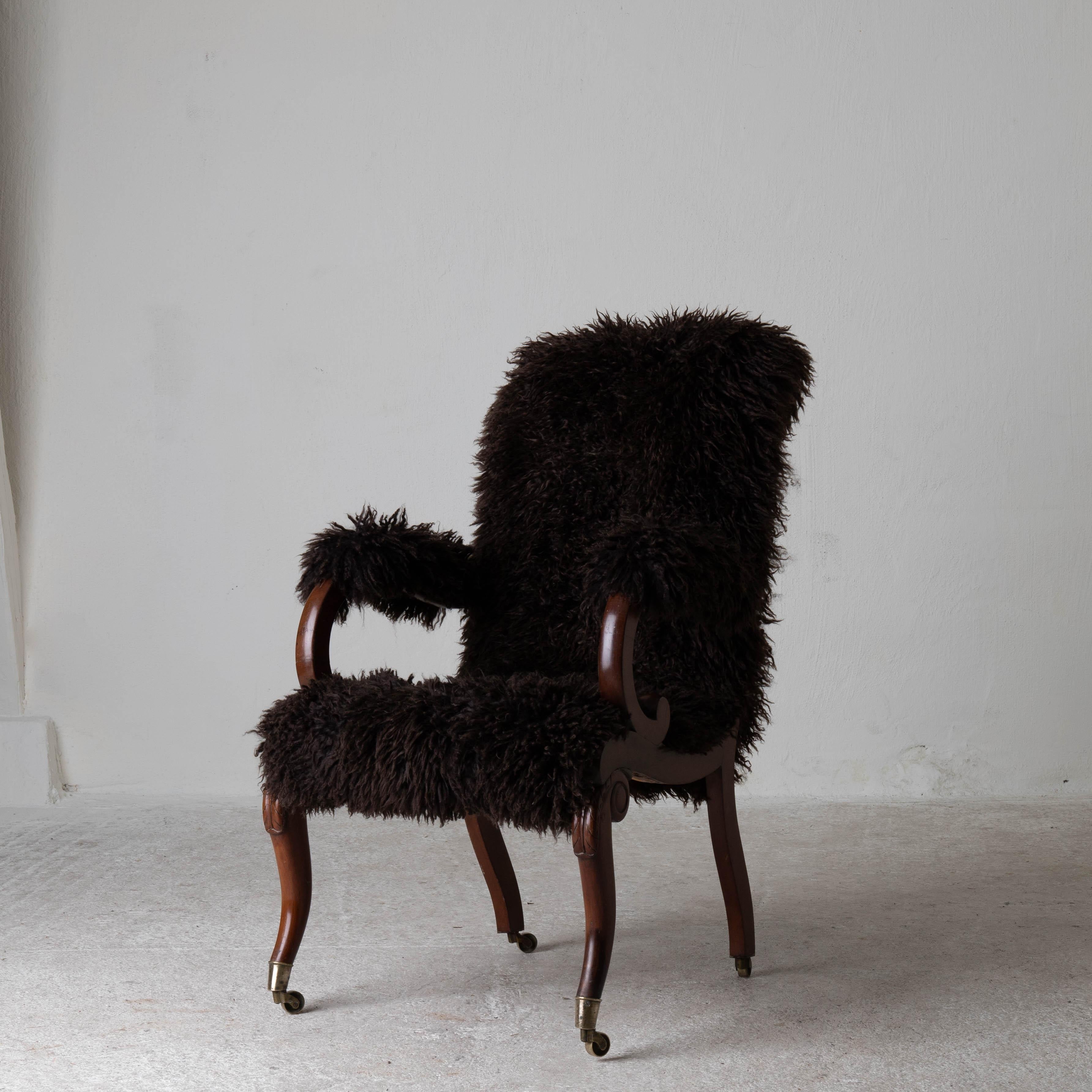 Armchair Sweden late 19th century brown Swedish. A chair made during the later part of the 19th century. Reupholstered in a chocolate brown long haired fur. Frame made in mahogany and legs ending in brass casters.

    