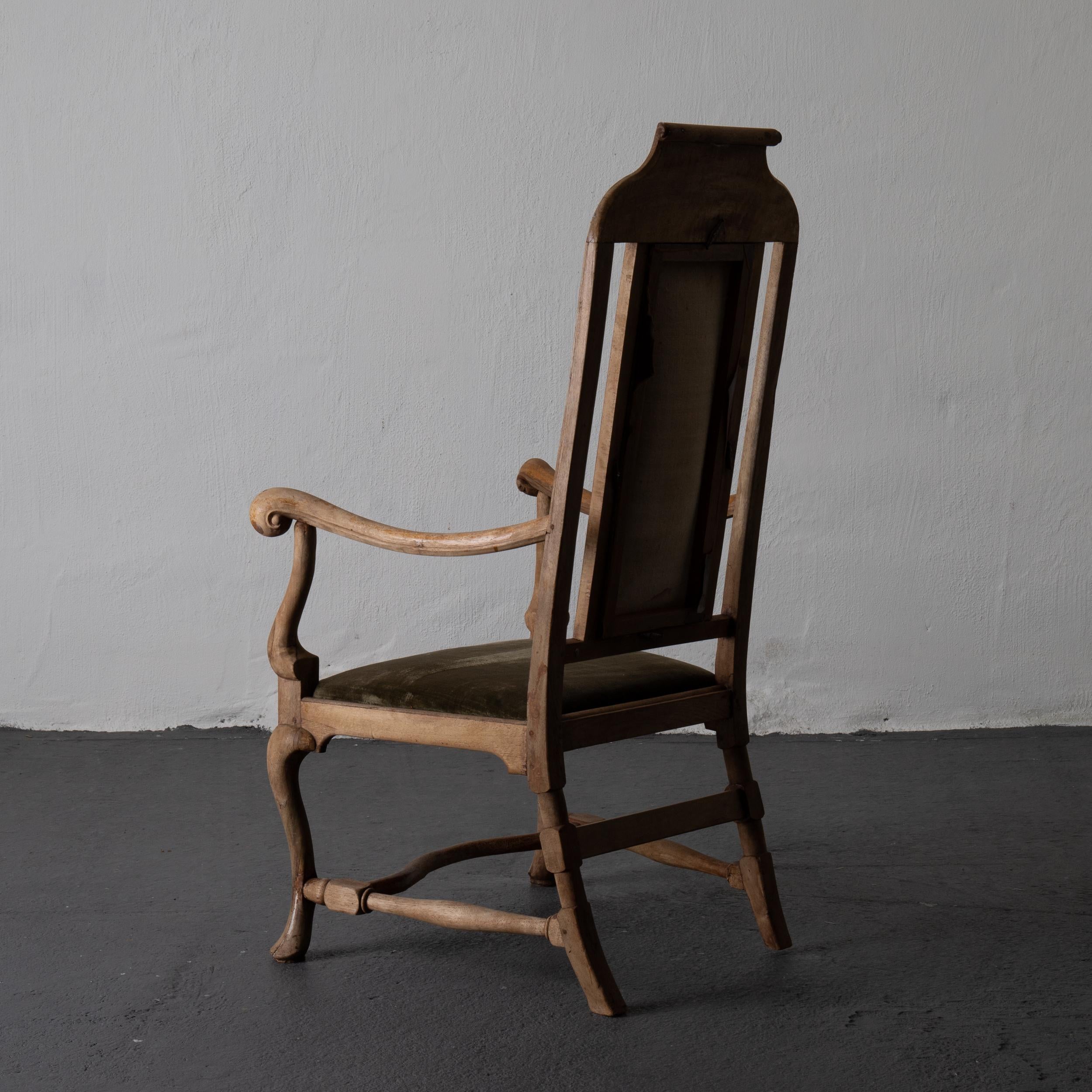 Armchair Swedish Baroque wood green velvet Sweden. An armchair made during the Baroque period in Sweden. A raw wooden frame with beautiful carvings. Upholstered in a slightly faded green velvet.