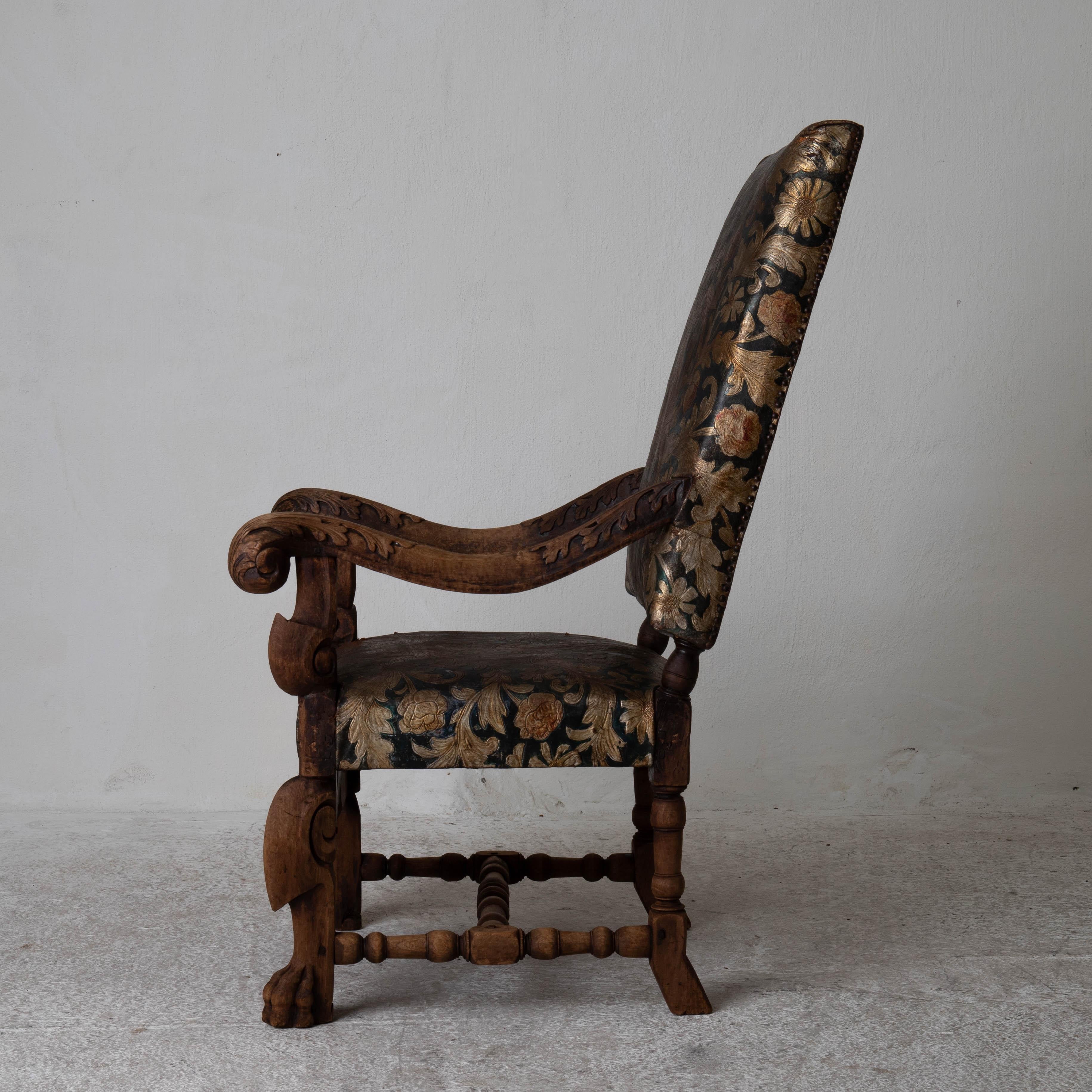 Sessel schwedische Frühbarockzeit vergoldetes Leder Schweden. Ein großzügig bemessener Sessel aus der Zeit des karolingischen Barocks (1650-1720) in Schweden. Der Rahmen ist aus Eichenholz mit rohem Finish, verziert mit Löwenfüßen und geschnitzten