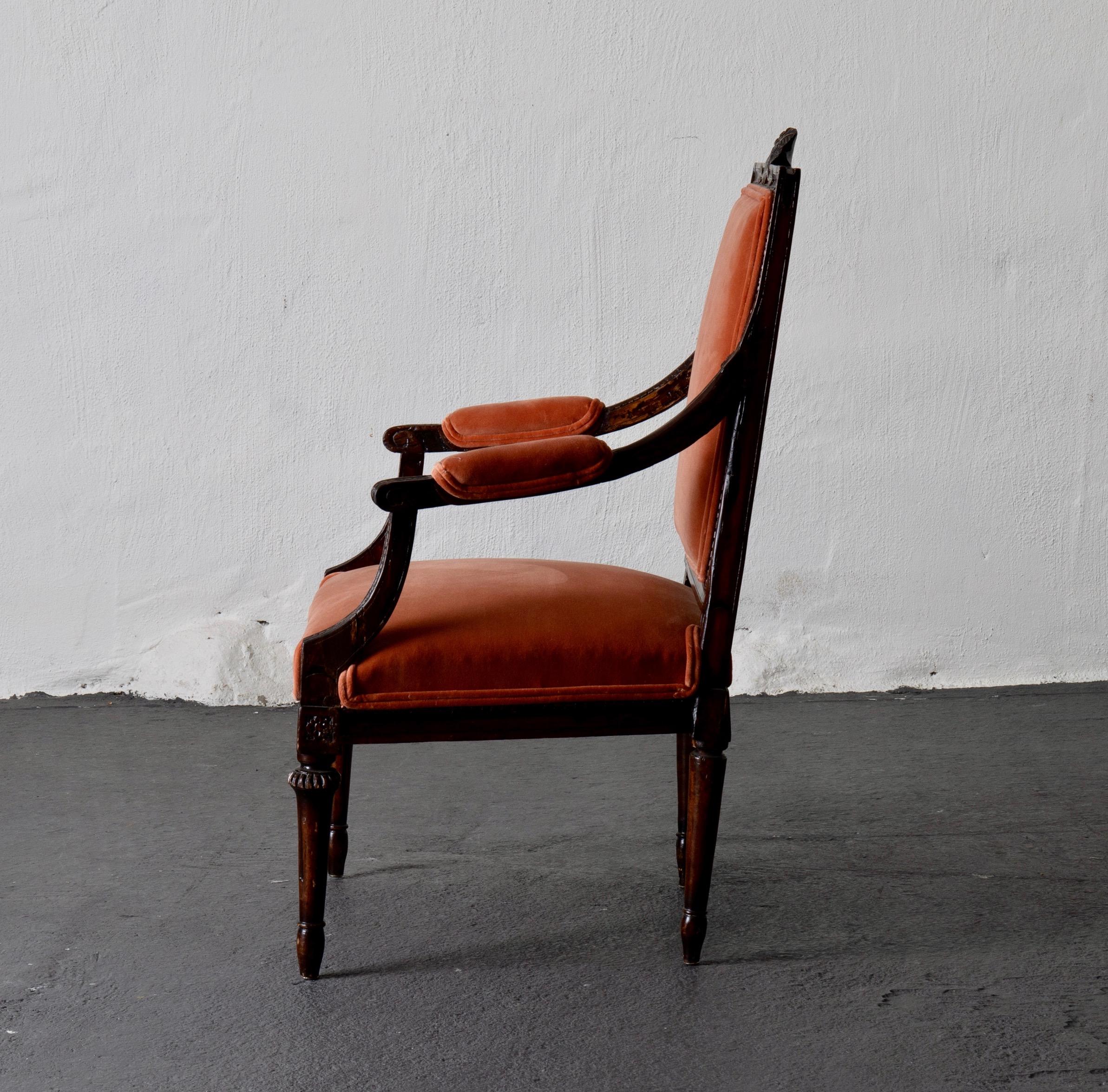 Armchair Swedish Gustavian dark apricot velvet, Sweden. An armchair made in Sweden during the Gustavian period (1790-1810). Carvings on backrest and frieze in the shape of a so called “humle flower