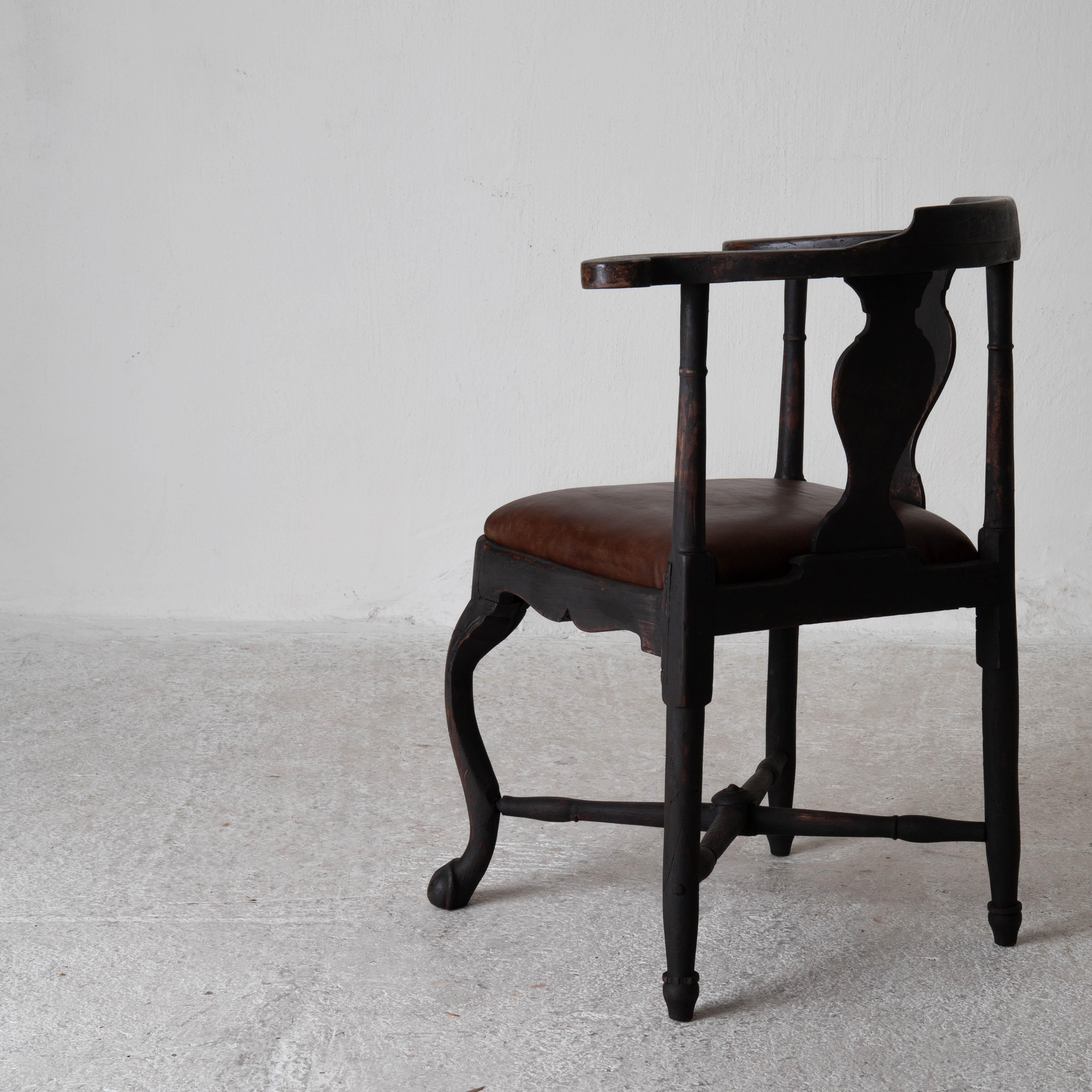 Armchair Swedish Rococo period black brown Sweden. An armchair called powder chair made during the Rococo period 1750-1775 in Sweden. Refinished in our Black and reupholstered in a brown vintage leather. Front leg ending in a claw and ball. Urn