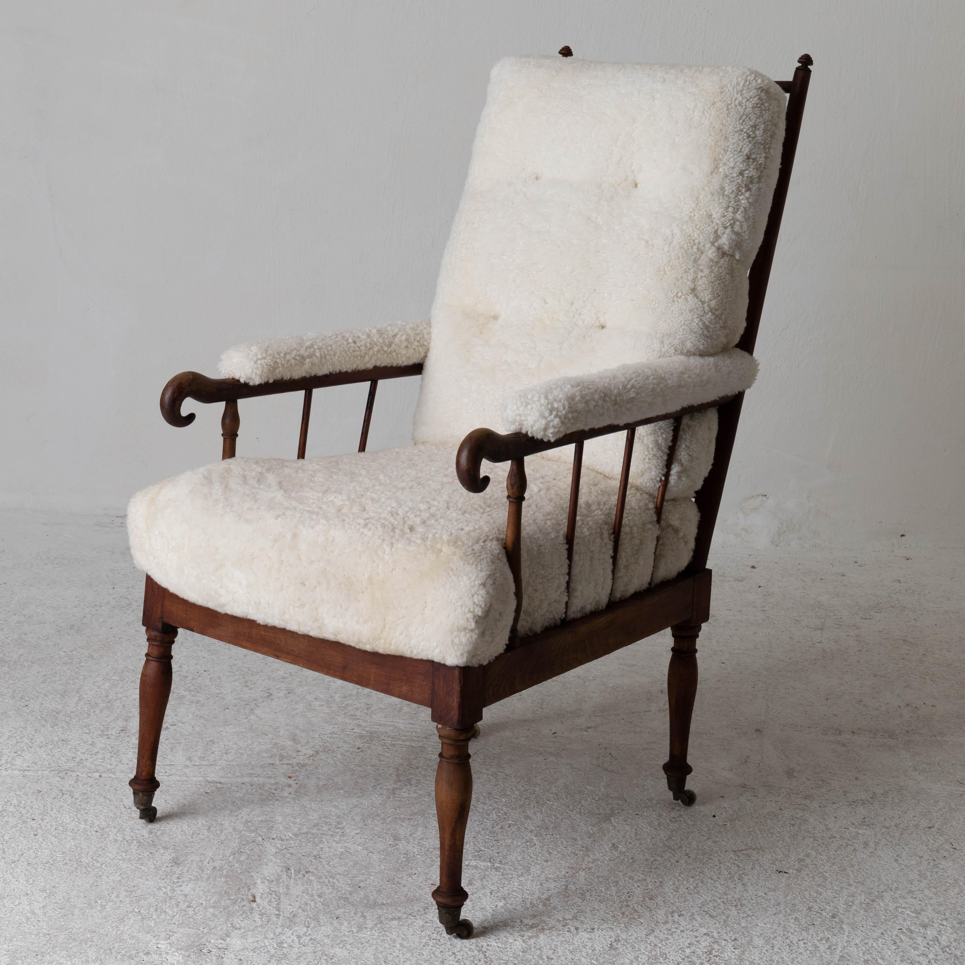 Armchair Swedish Shearling white brown frame 19th century Sweden. An armchair made during the 1840-50s in Sweden. Upholstered in a white shearling. Frame in a mid-brown wood.