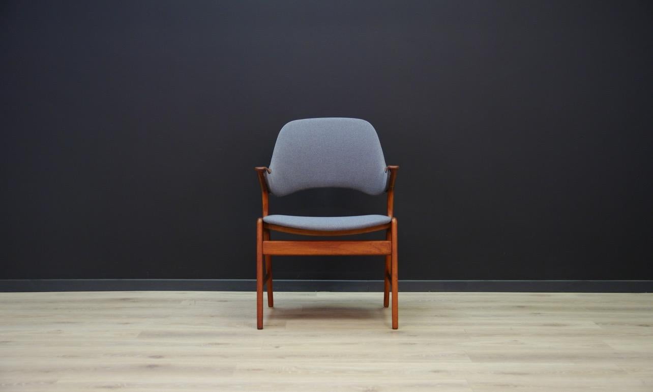 Original armchair from the 1960s-1970s, a beautiful minimalist form with sensational armrests. Teak construction covered with a new fabric (color - gray). Preserved in good condition (small bruises and scratches on wooden structure) - directly for