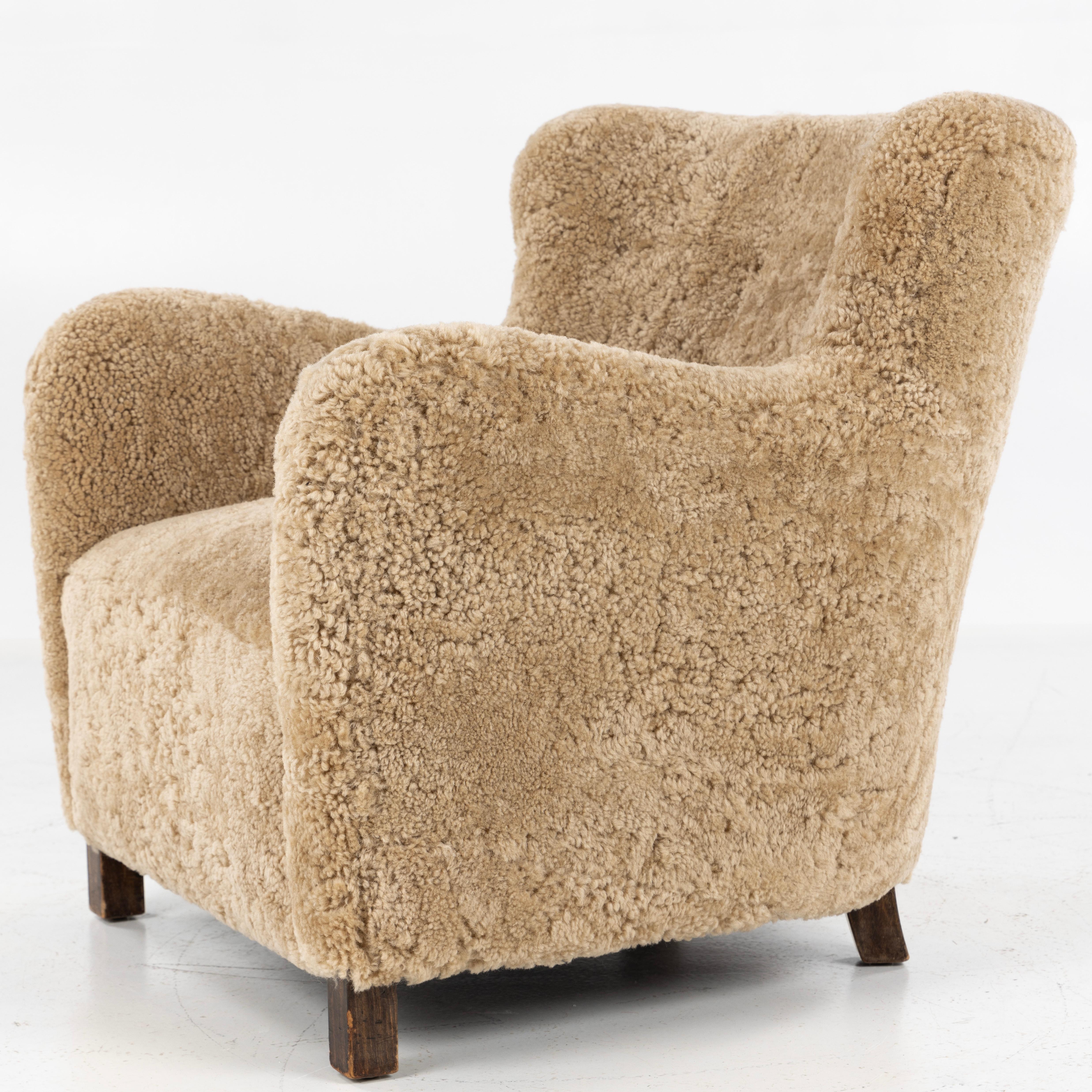 Rare vintage easy chair with new lambskin (colour: Honey) and legs of original stained beech. Designed in 1937 by Kaj Gottlob for cabinetmaker A. J. Iversen.