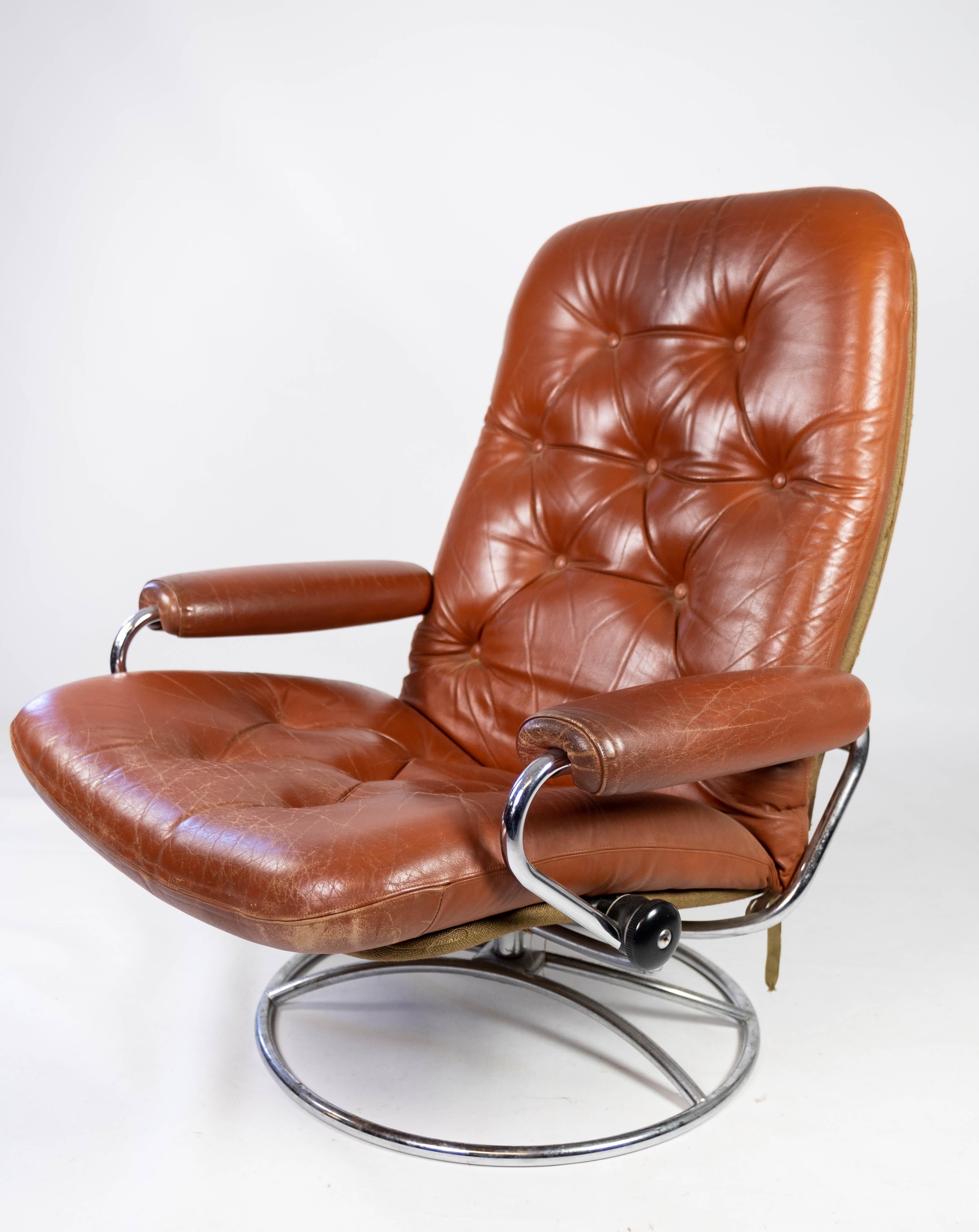 Armchair upholstered with red leather and frame of metal, of Danish design from the 1960s. The chair is in great vintage condition.
 
