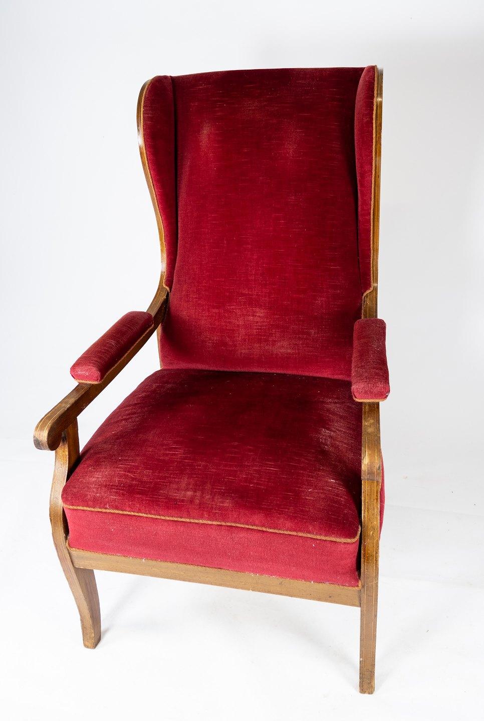 Armchair upholstered with red velvet and mahogany designed by Frits Henningsen. The chair is great vintage condition.