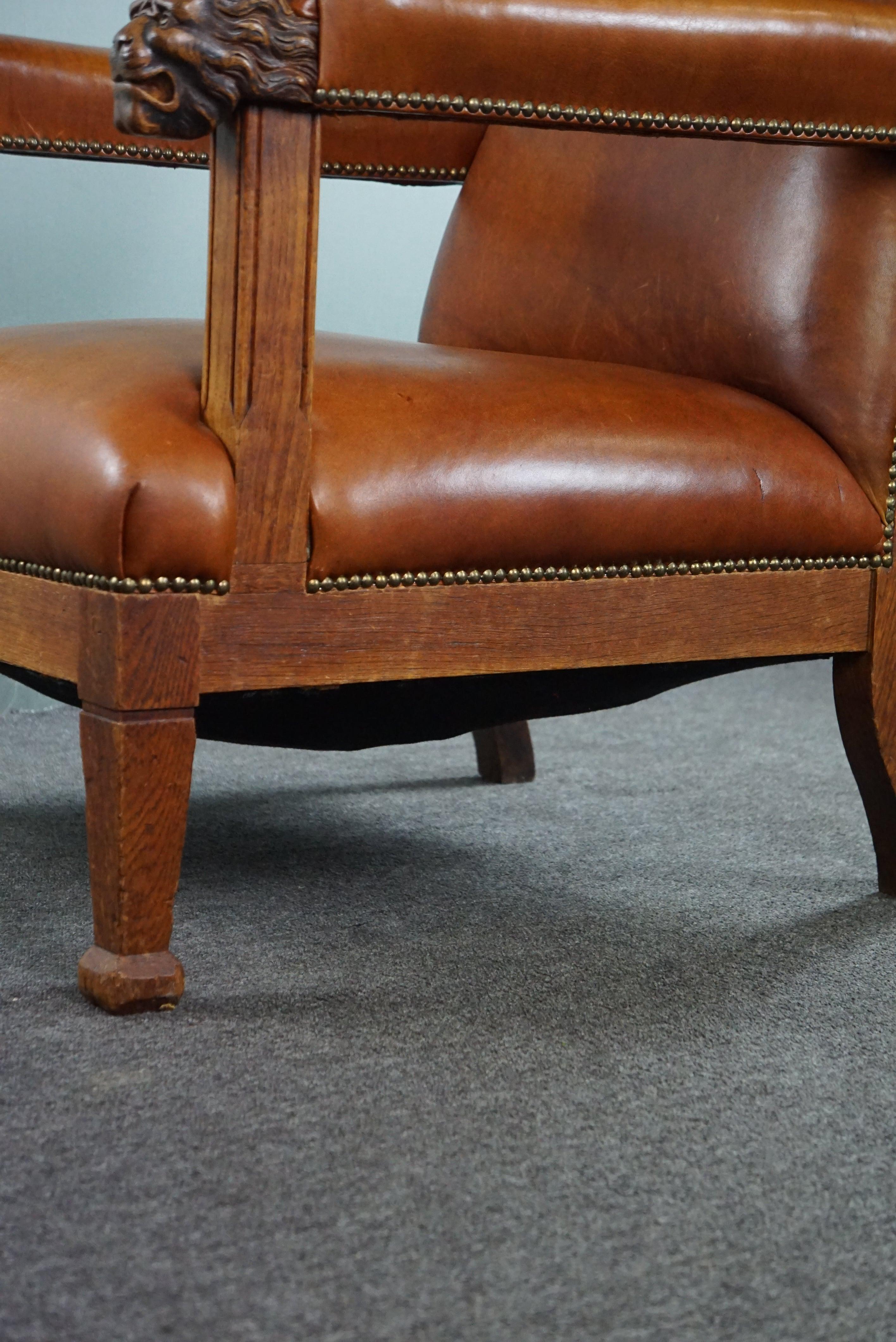 Armchair with lion heads reupholstered in cognac-colored cowhide For Sale 4
