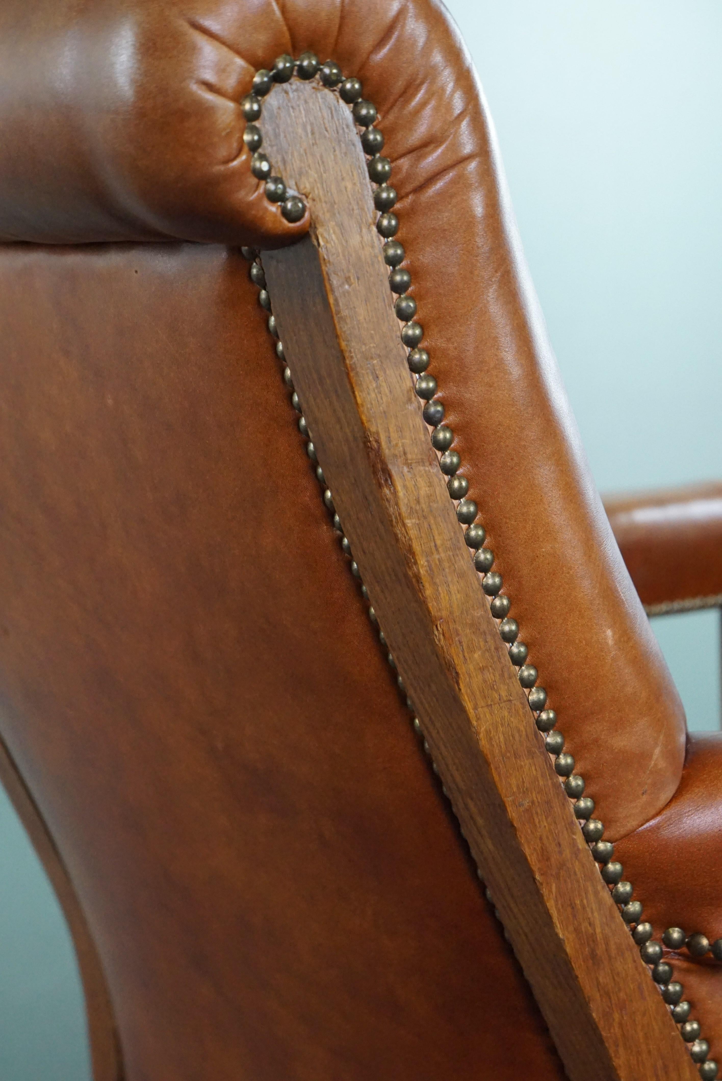 Armchair with lion heads reupholstered in cognac-colored cowhide For Sale 5